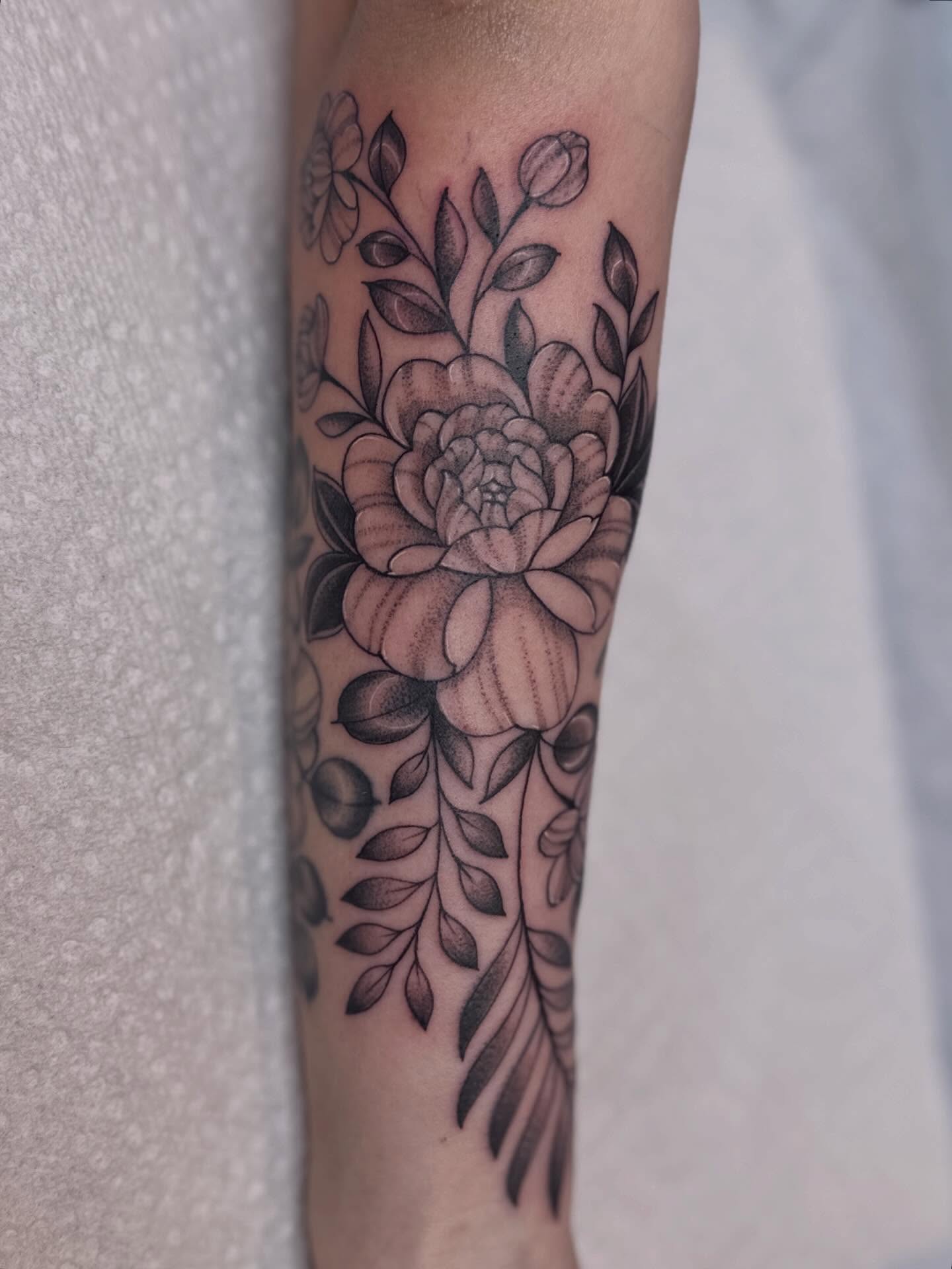 Floral bouquet dotwork tattoo on the forearm by Dani Di Pietrantonio