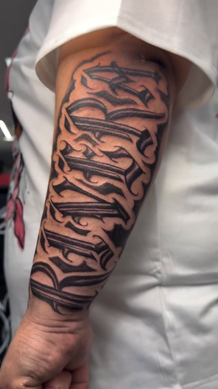 Gangsta font script tattoo on arm Chicano tattoo on the forearm by Betotats