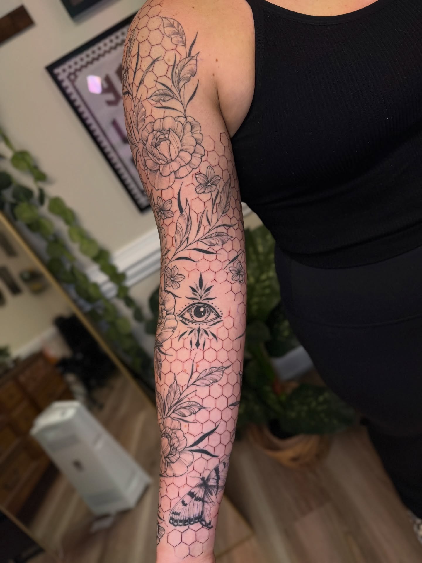 Floral and eye design geometric tattoo on the forearm by McKenna