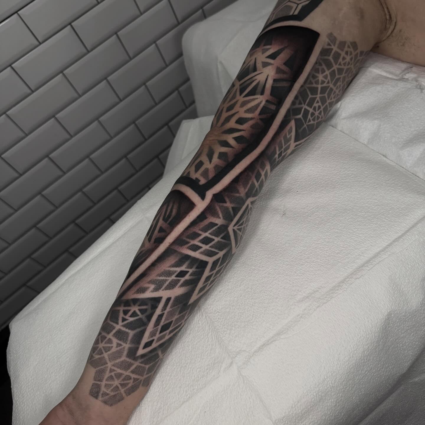 Geometric pattern geometric tattoo on the forearm by Kevin Johnson