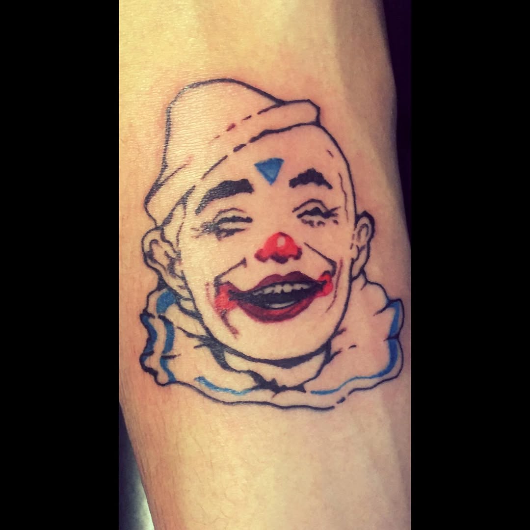 Clown face realism tattoo on the forearm by Dharm, Denver, Colorado