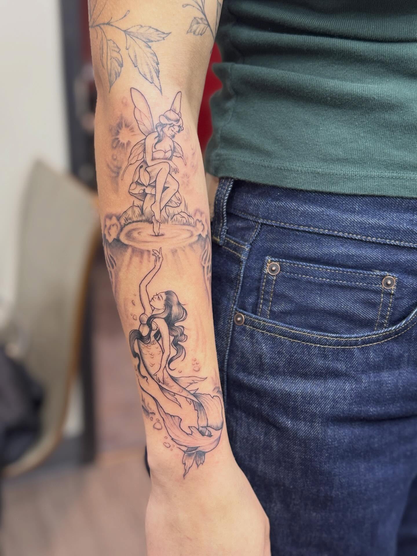 Fairy and mermaid black and grey tattoo on the forearm by Rebecca Rose