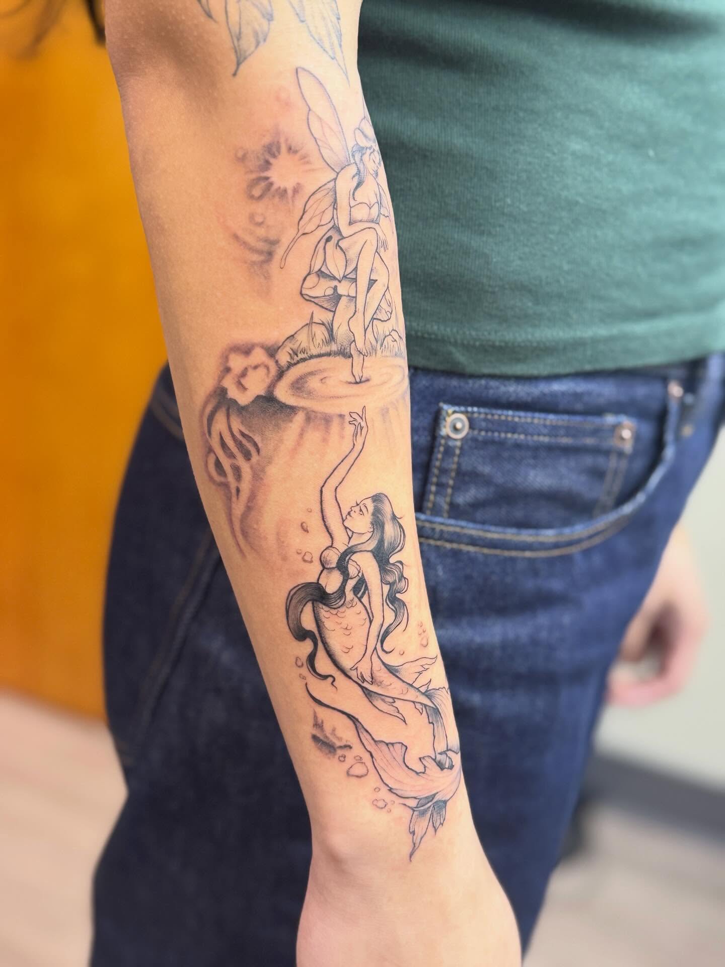 Mermaid and fairy realism tattoo on the forearm by Rebecca Rose