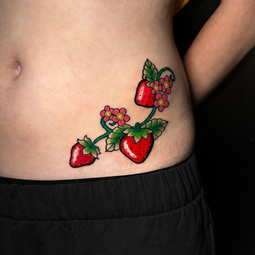 Strawberries and flowers American traditional tattoo on the torso by Tess