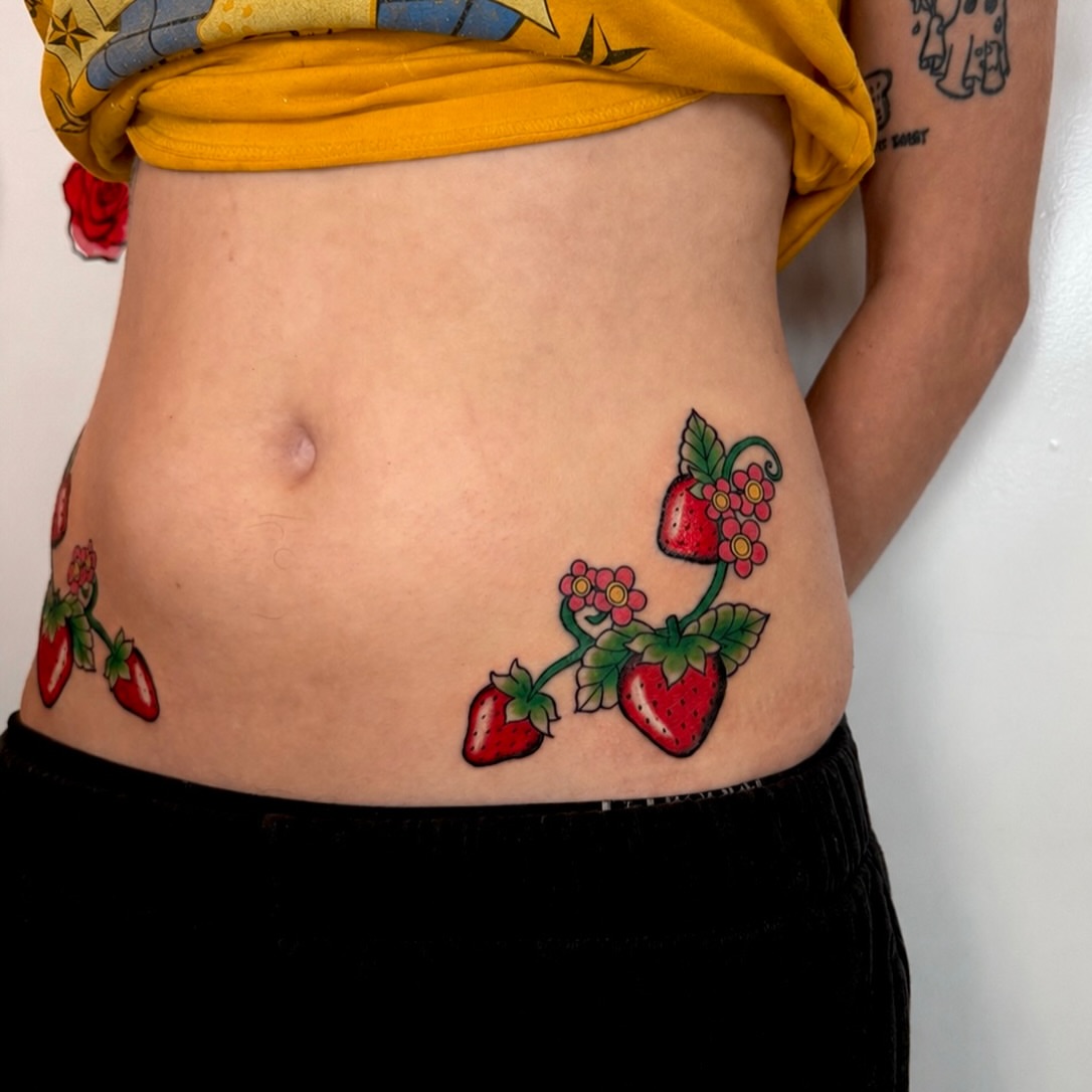 Strawberries and flowers American traditional tattoo on the torso by Tess