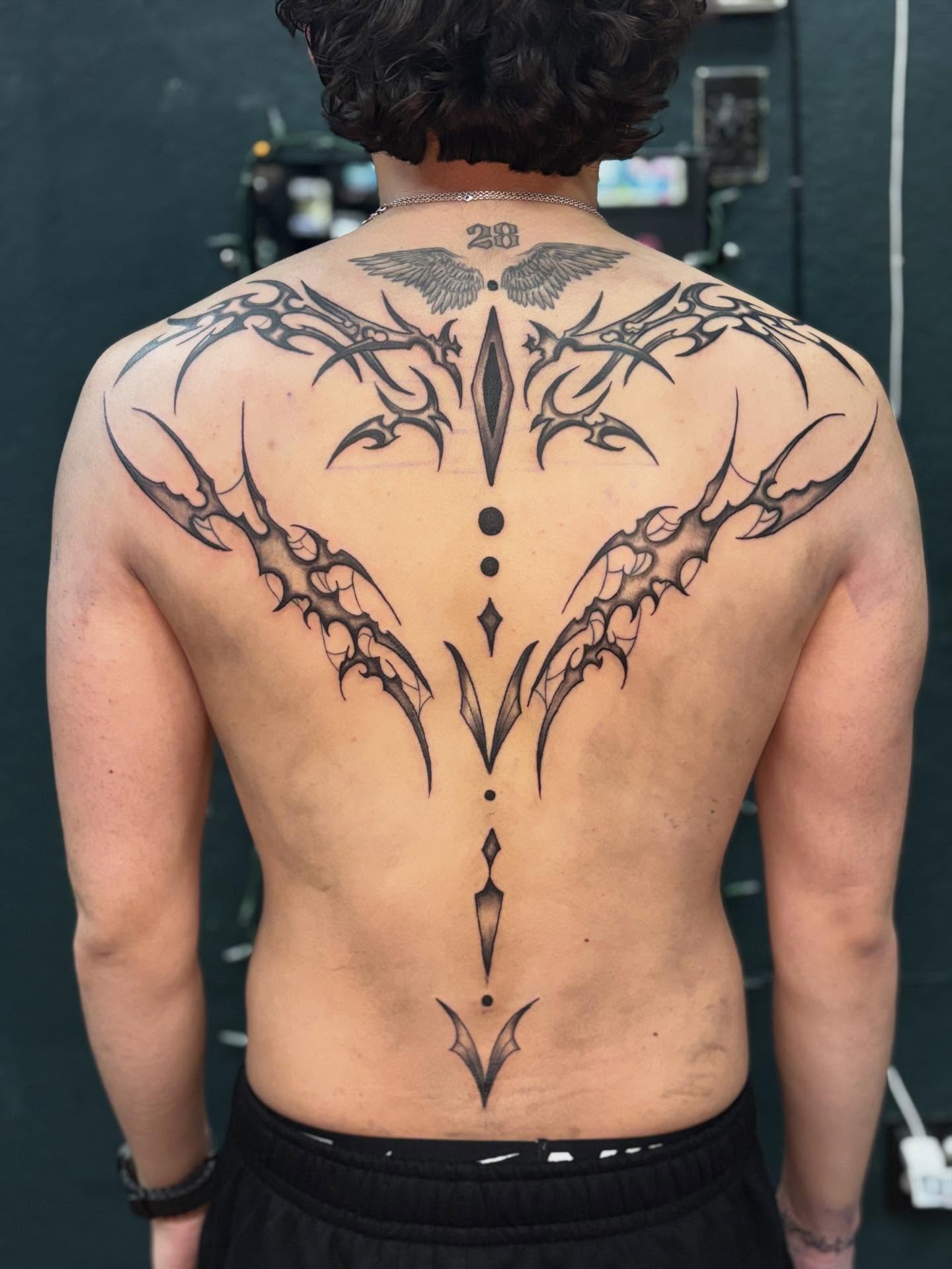 Tribal wings tribal tattoo on the back by Emma ๐