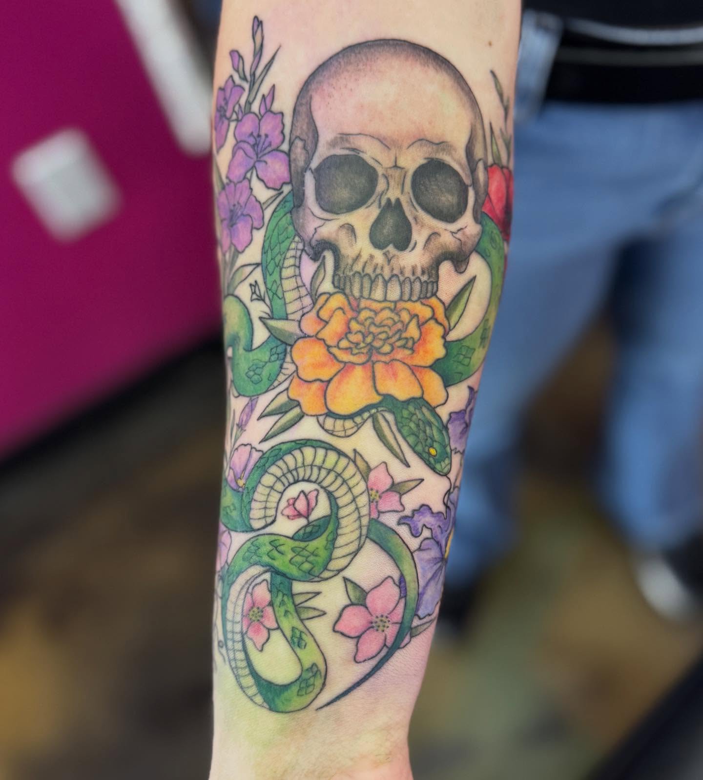 Skull and snake neo-traditional tattoo on the forearm by Jada Reynolds