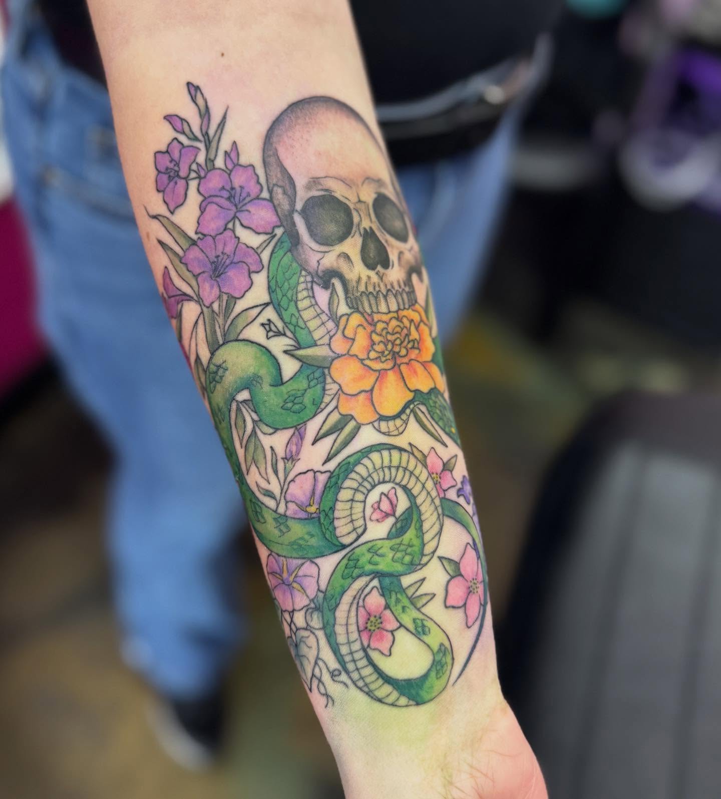 Skull and snake American traditional tattoo on the forearm by Jada Reynolds