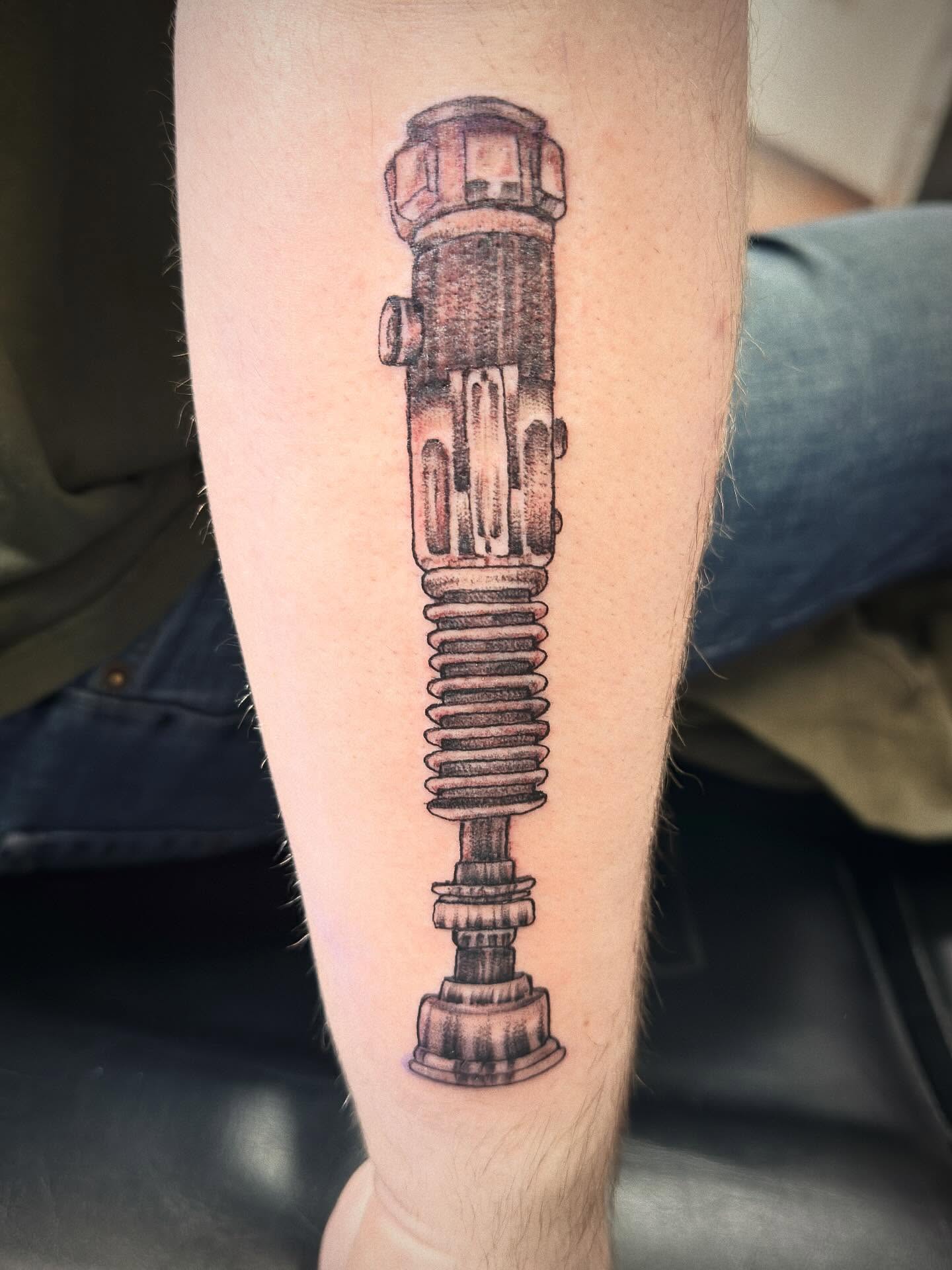 Gun black and grey tattoo on the forearm by Tasha