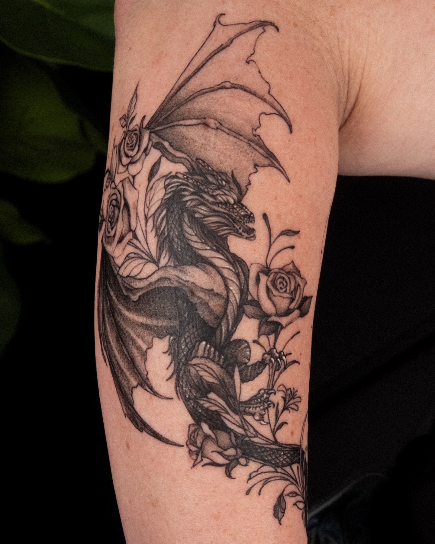 Dragon and roses realism tattoo on the forearm by Wong Lee