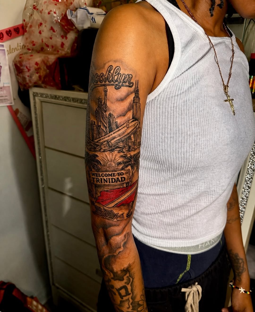 Brooklyn and statue of liberty surrealism tattoo on the upper arm by JayyeSosa