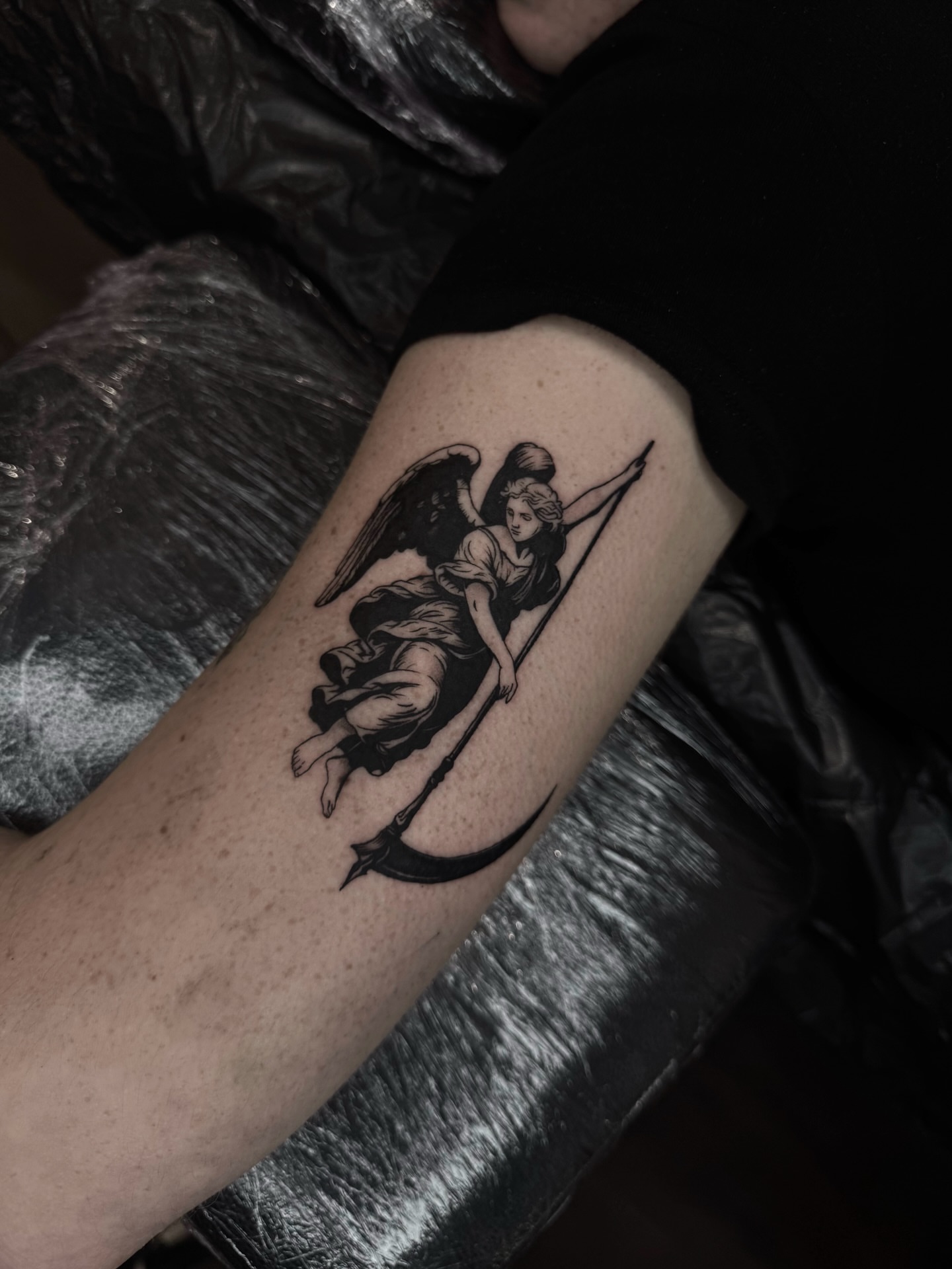 Angel with scythe black and grey tattoo on the forearm by Blackwork Vamos
