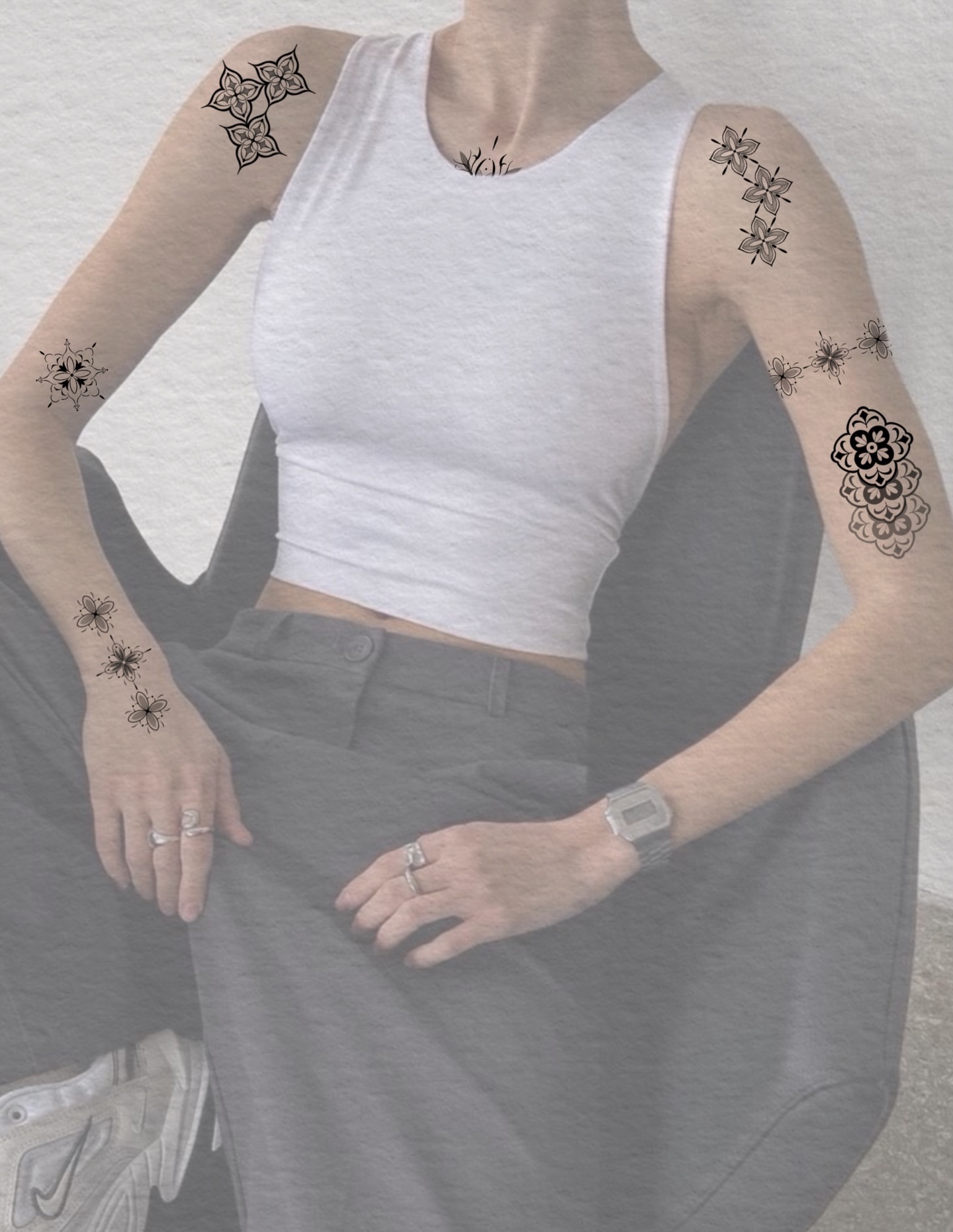Floral patterns black and grey tattoo on the upper arm by Suzy