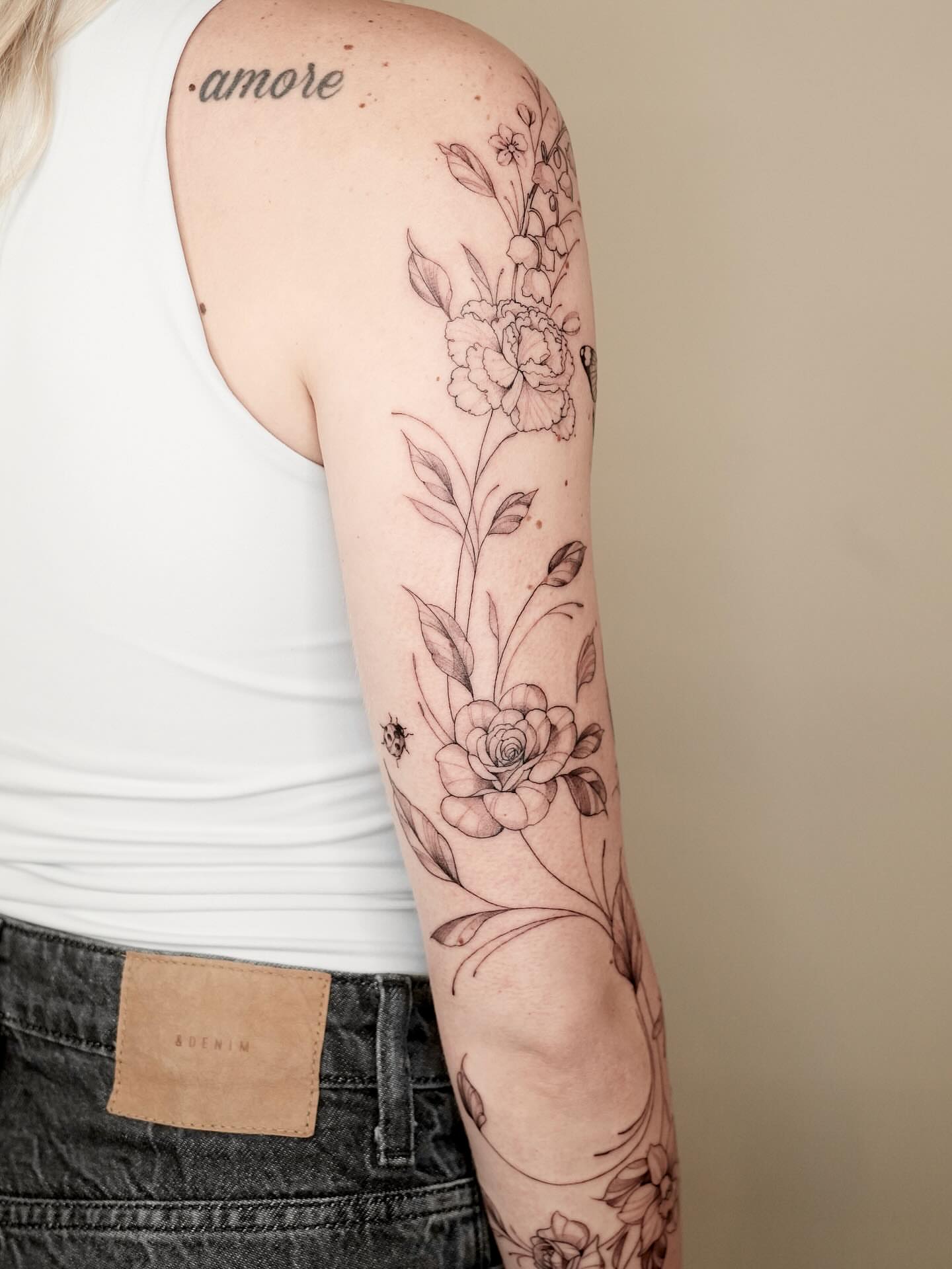 Floral arrangement fine line tattoo on the forearm by Marianna D D King
