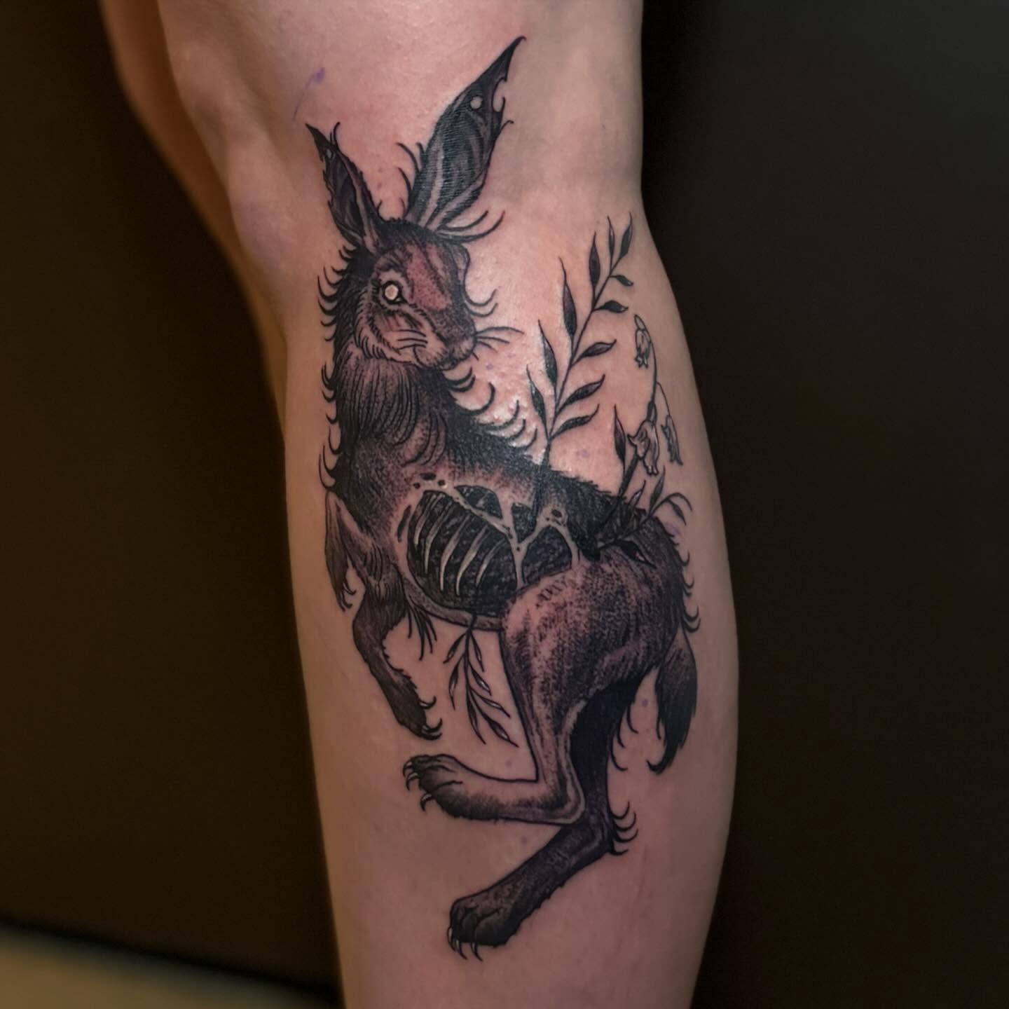 Hare with plant black and grey tattoo on the forearm by Zeninkz