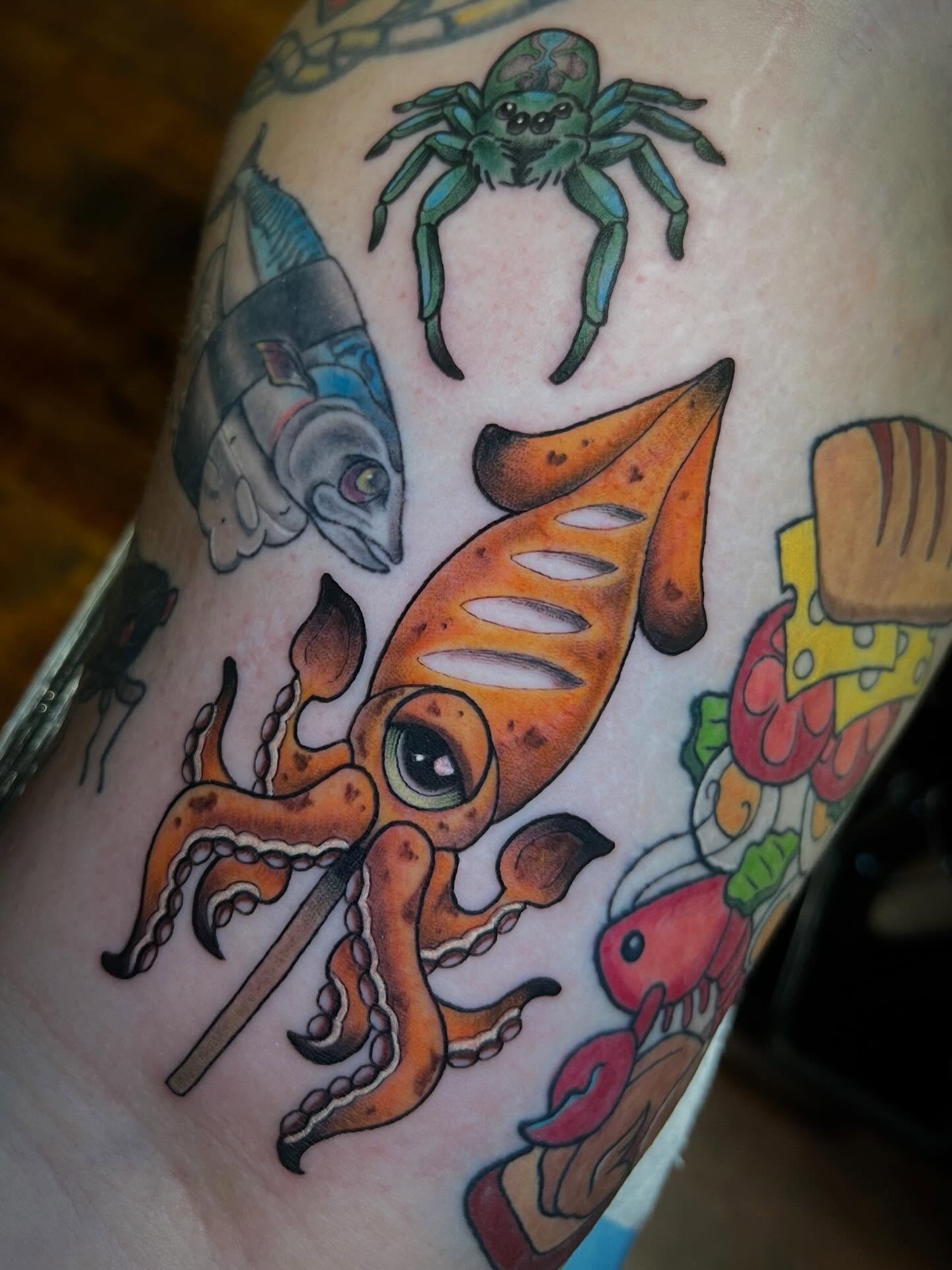 Squid and fish American traditional tattoo on the forearm by Katie Ann Tattoos