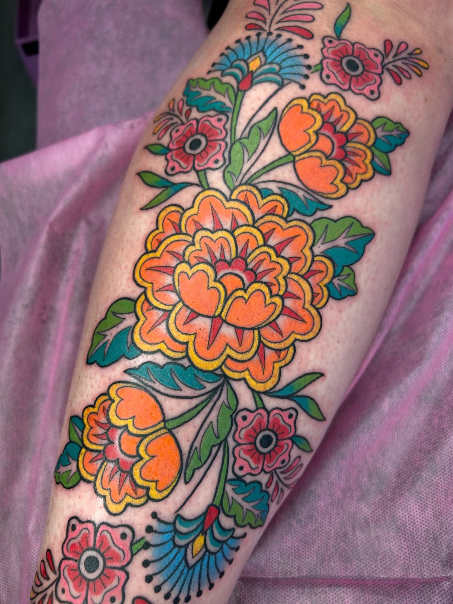 Floral bouquet American traditional tattoo on the forearm by Audrey Migitsch