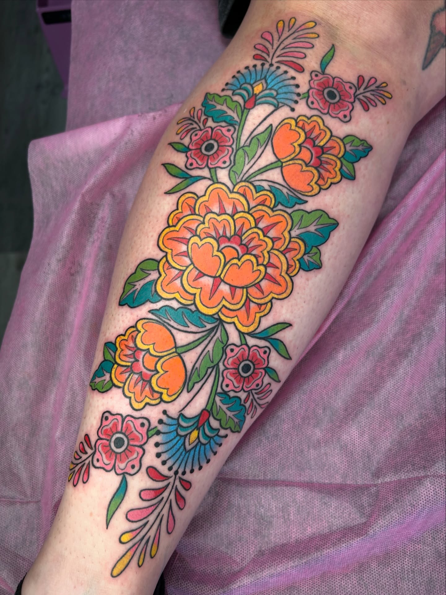 Floral bouquet American traditional tattoo on the forearm by Audrey Migitsch