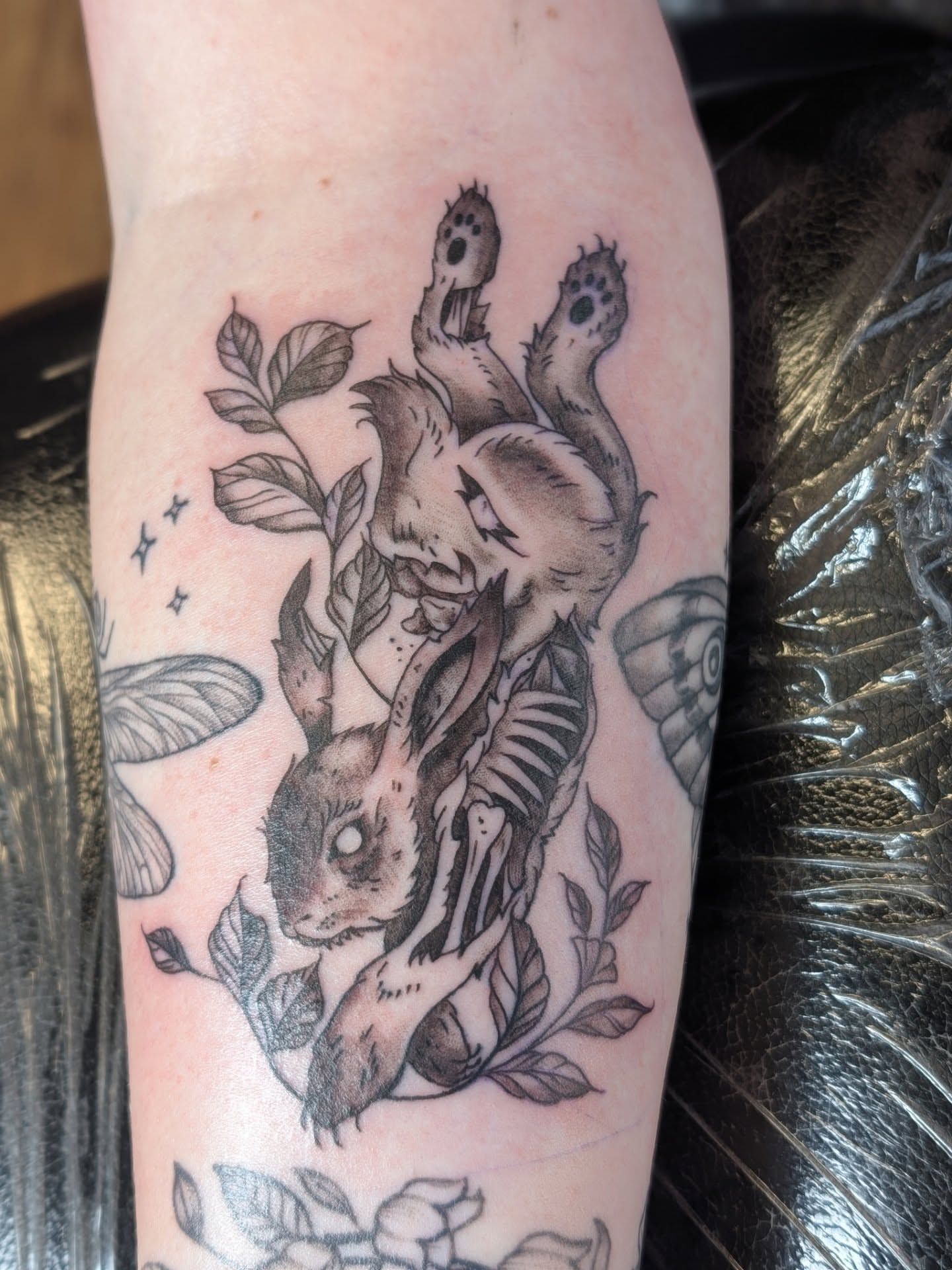 Rabbit and lion realism tattoo on the forearm by Chad Nuber