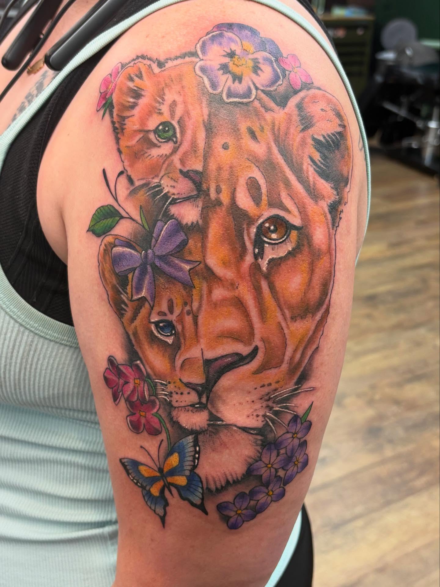 Lioness and cub realism tattoo on the upper arm by Robbie Reel, Wichita, Kansas