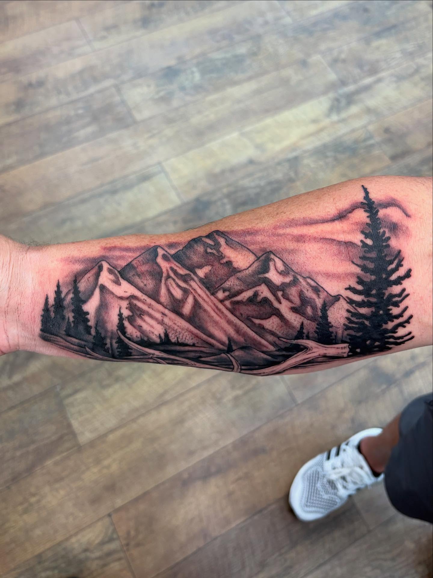 Mountain landscape black and grey tattoo on the forearm by Robbie Reel, Wichita, Kansas
