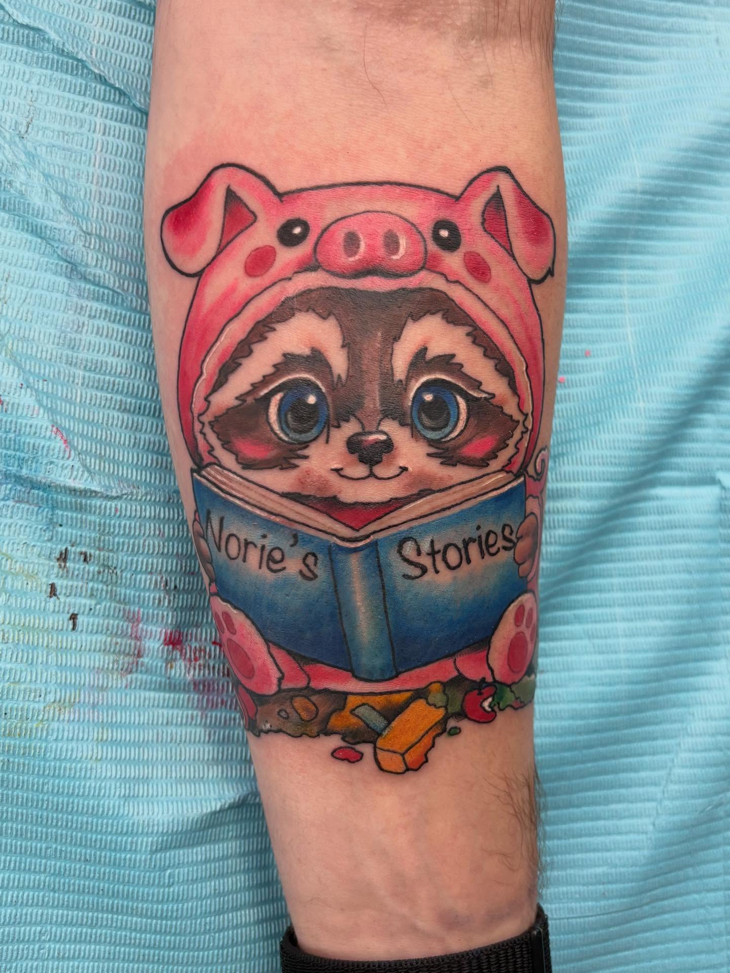 Raccoon reading book new school tattoo on the forearm by Robbie Reel, Wichita, Kansas