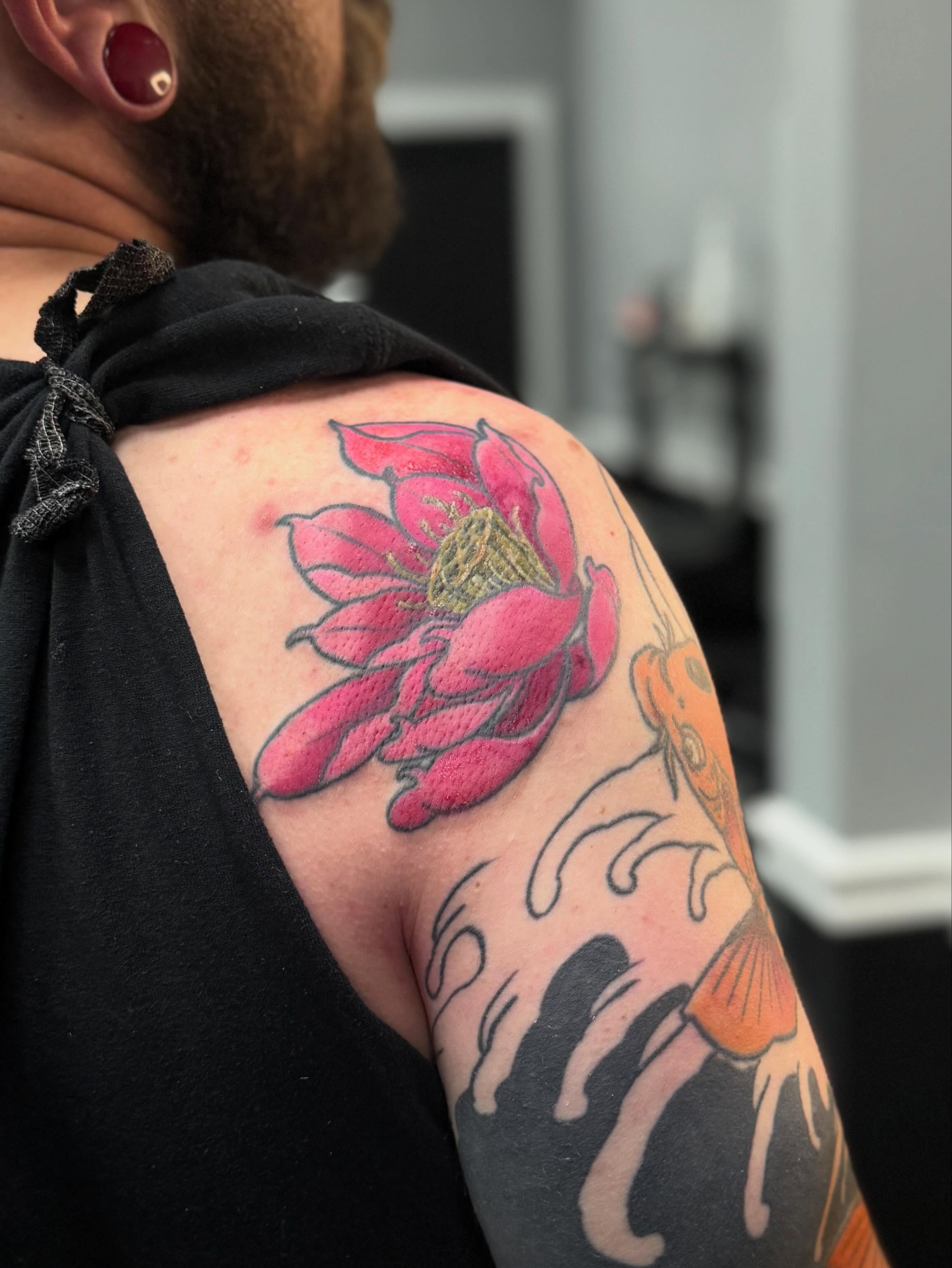 Lotus flower American traditional tattoo on the shoulder by Marie Amor🌙