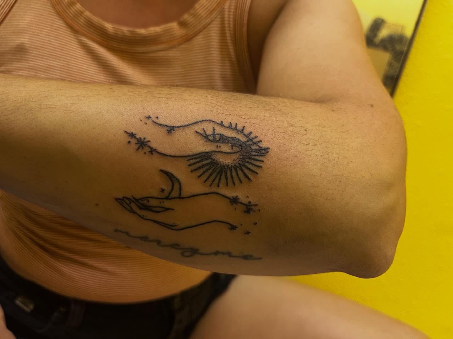 Eye and sun fine line tattoo on the forearm by Rafaela Lopez