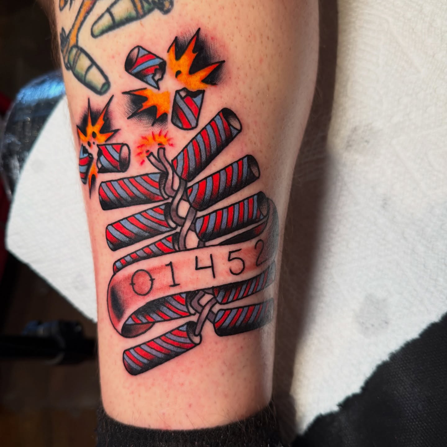 Firecrackers and numbers American traditional tattoo on the forearm by πππ’π―π’π¨ πππΆπ©π¬π―π, Manchester, New Hampshire