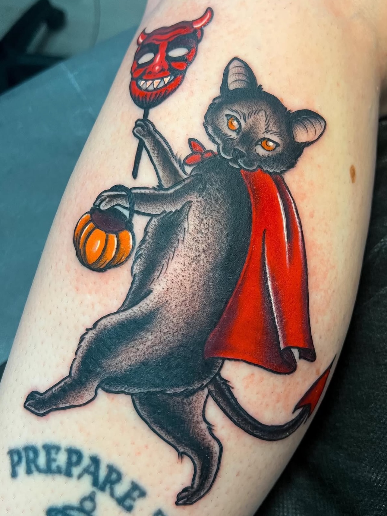 Cat in devil costume American traditional tattoo on the forearm by πΊπππππ π»πππππππ