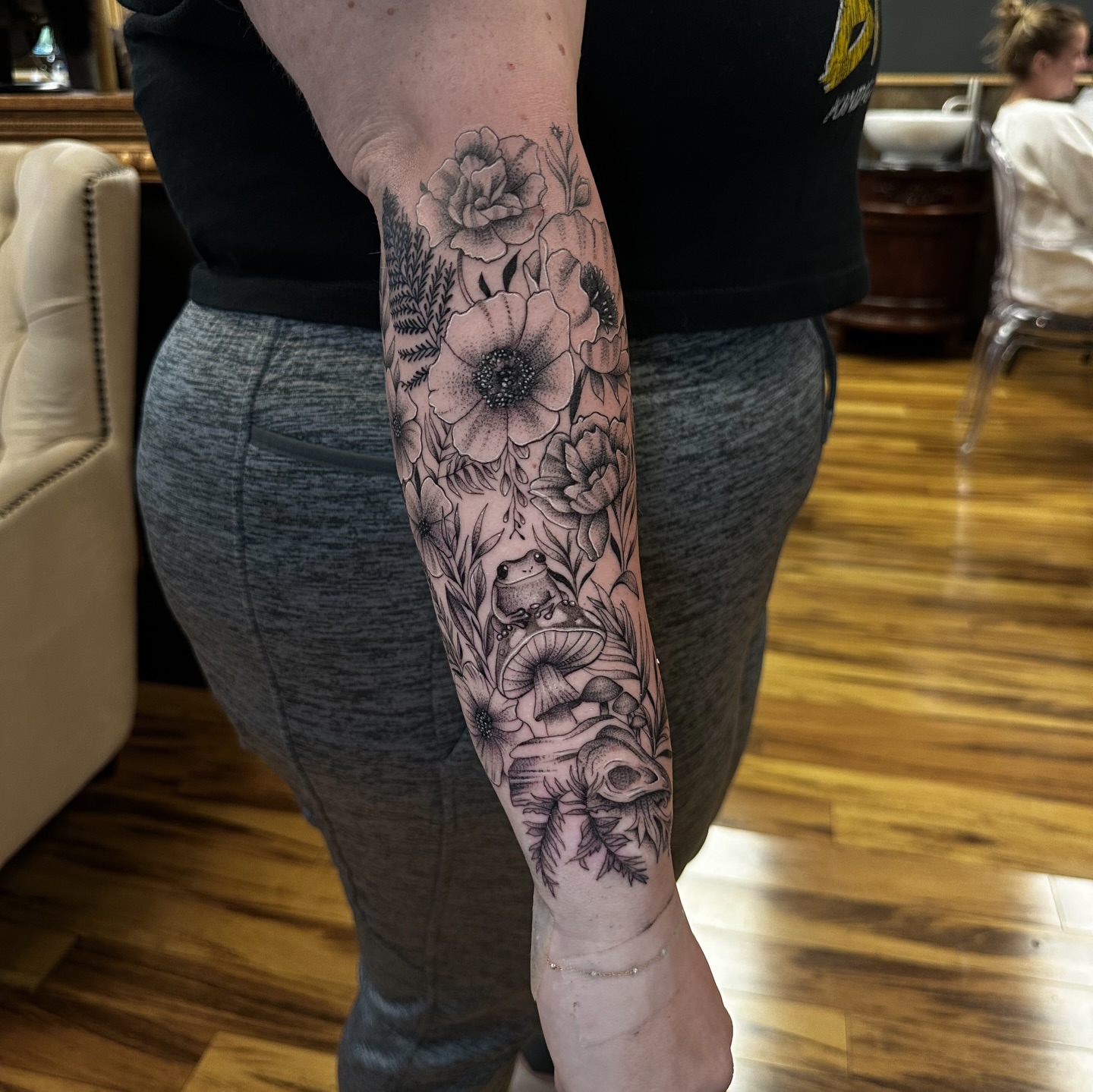 Floral and frog dotwork tattoo on the forearm by Leo Fernandes, Danvers, Massachusetts