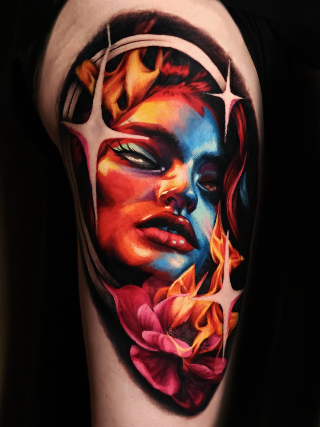 Woman's face with fire and flower surrealism tattoo on the shoulder by Júlia Sorrino