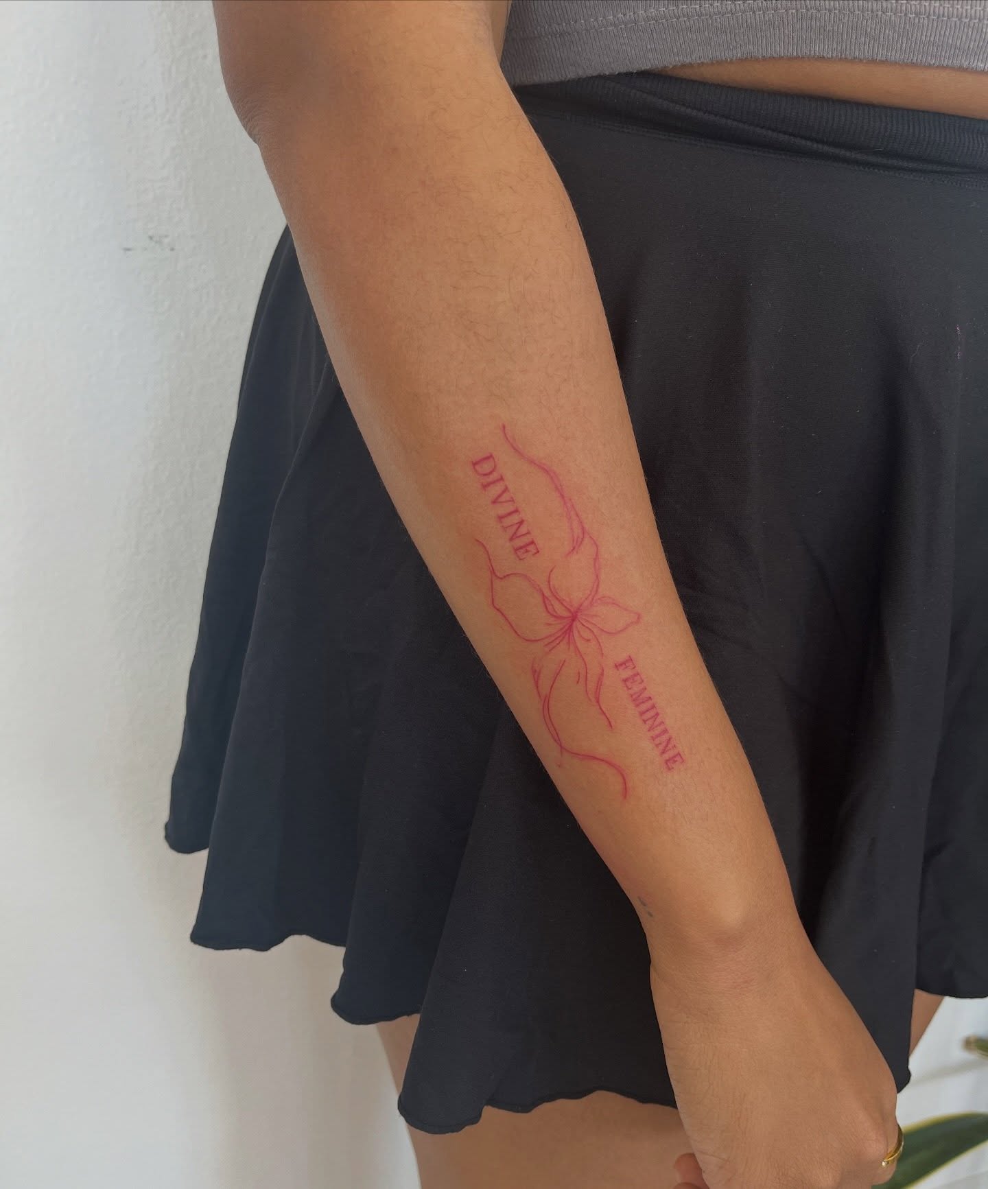 Flower fine line tattoo on the forearm by kt