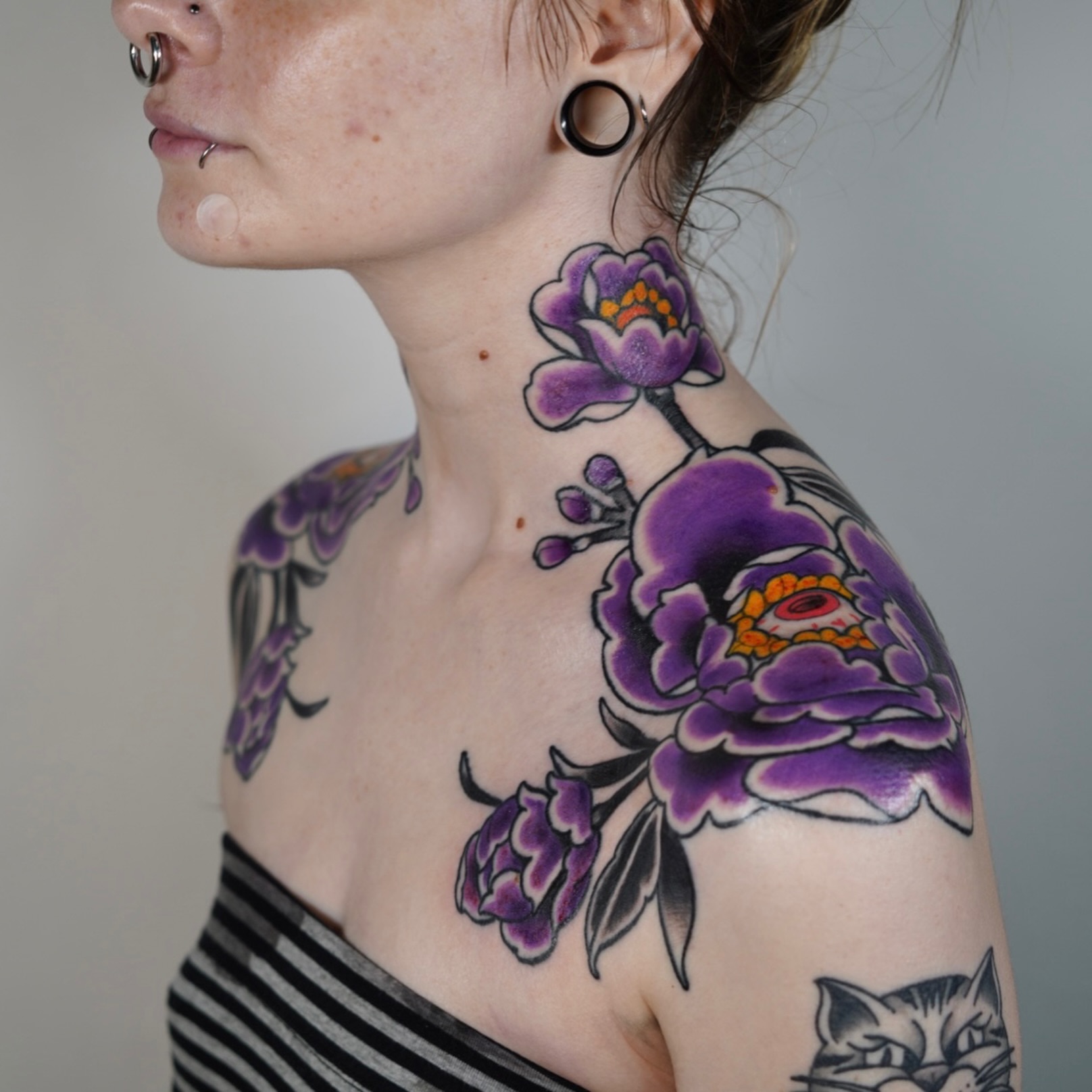 Purple flowers American traditional tattoo on the shoulder by autumn sky