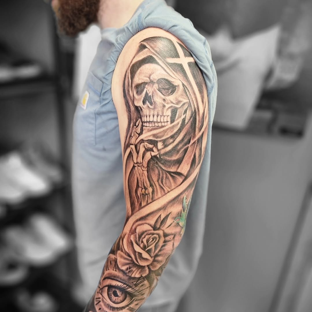 Grim reaper with rose and eye realism tattoo on the forearm by Dennis Foust