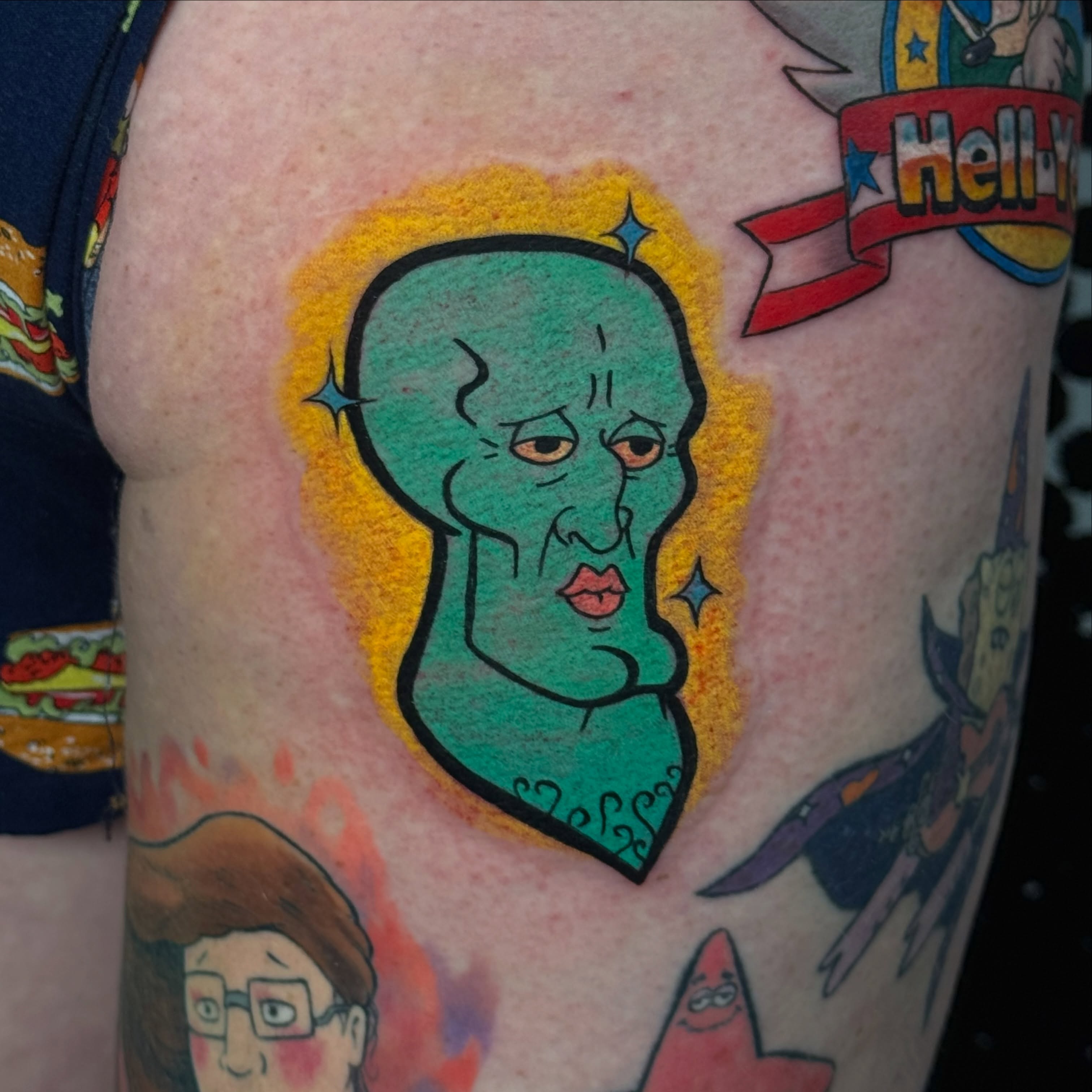 Alien head American traditional tattoo on the upper arm by Derek Foferek, Charlotte, North Carolina