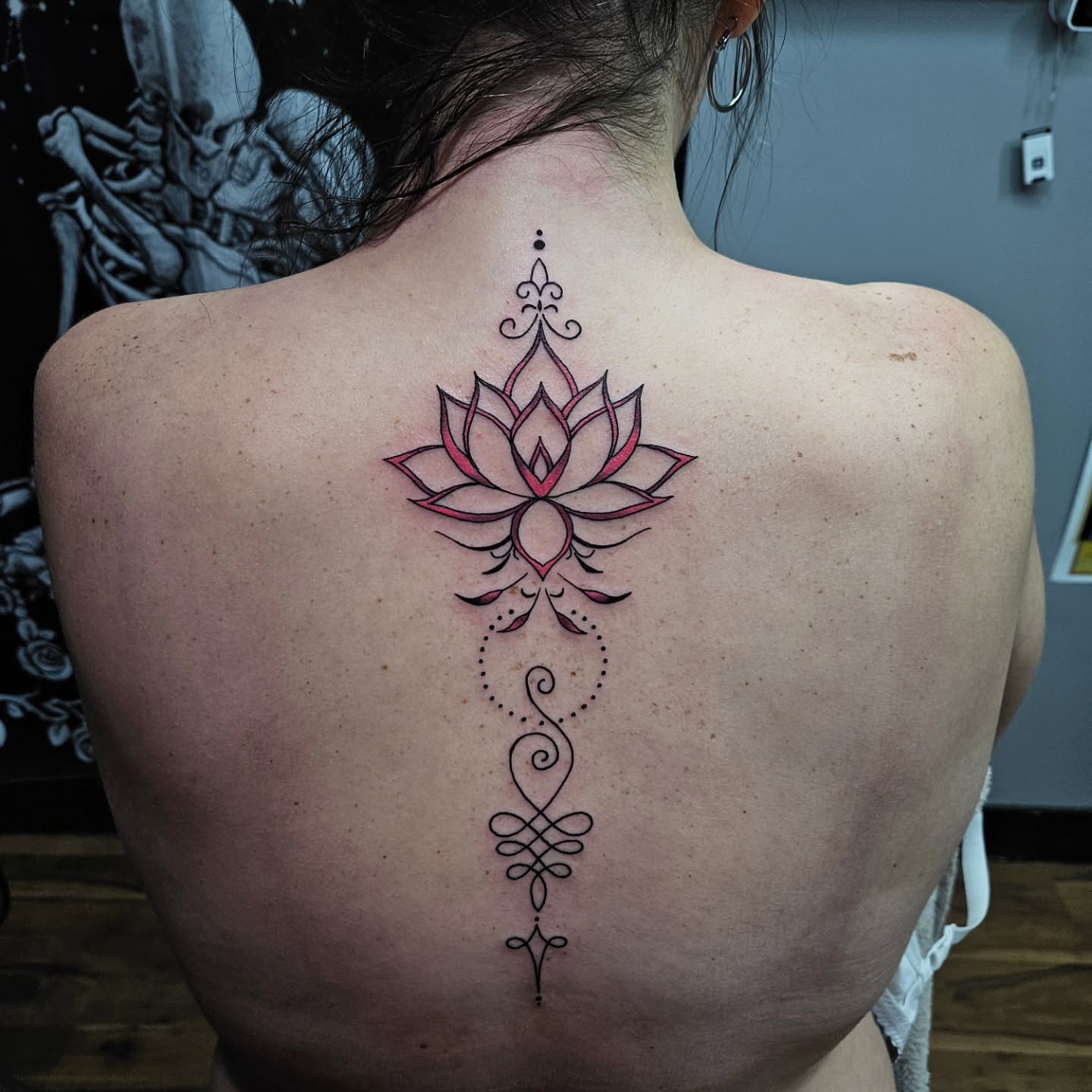 Lotus flower geometric tattoo on the back by Danny