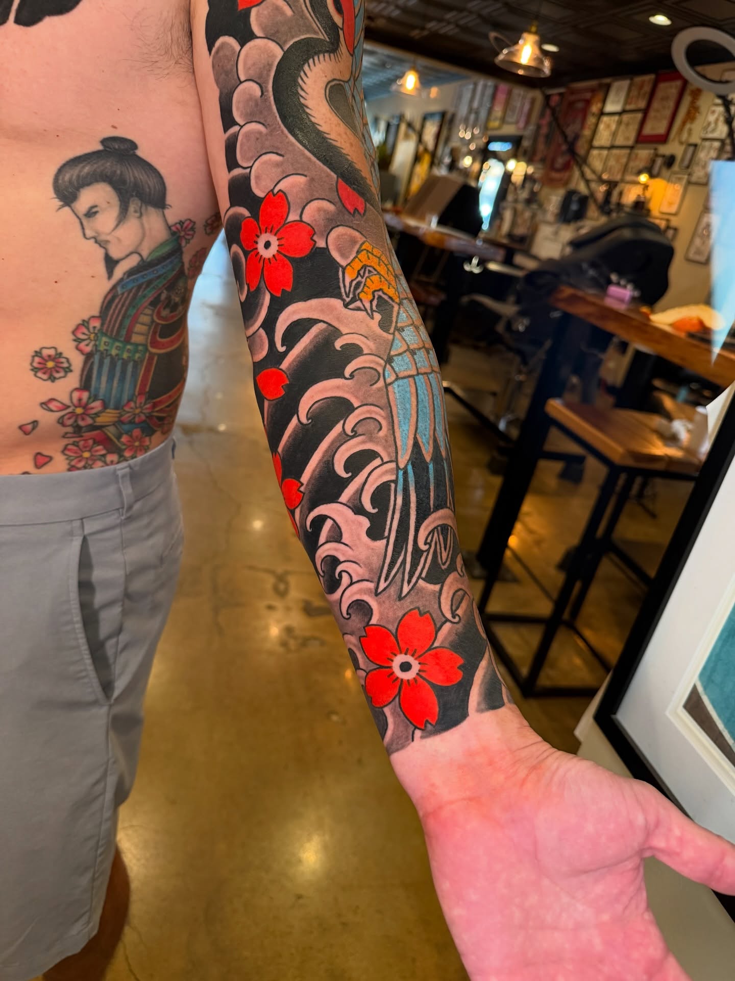 Wave and flowers japanese irezumi tattoo on the forearm by Tyler Brown, San Diego, California