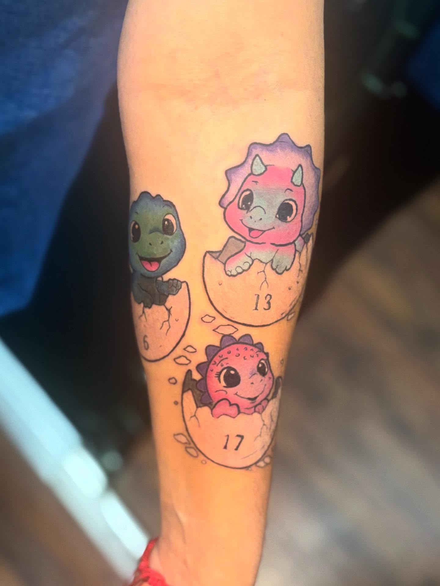 Dinosaur hatchlings dotwork tattoo on the forearm by Emma ๐