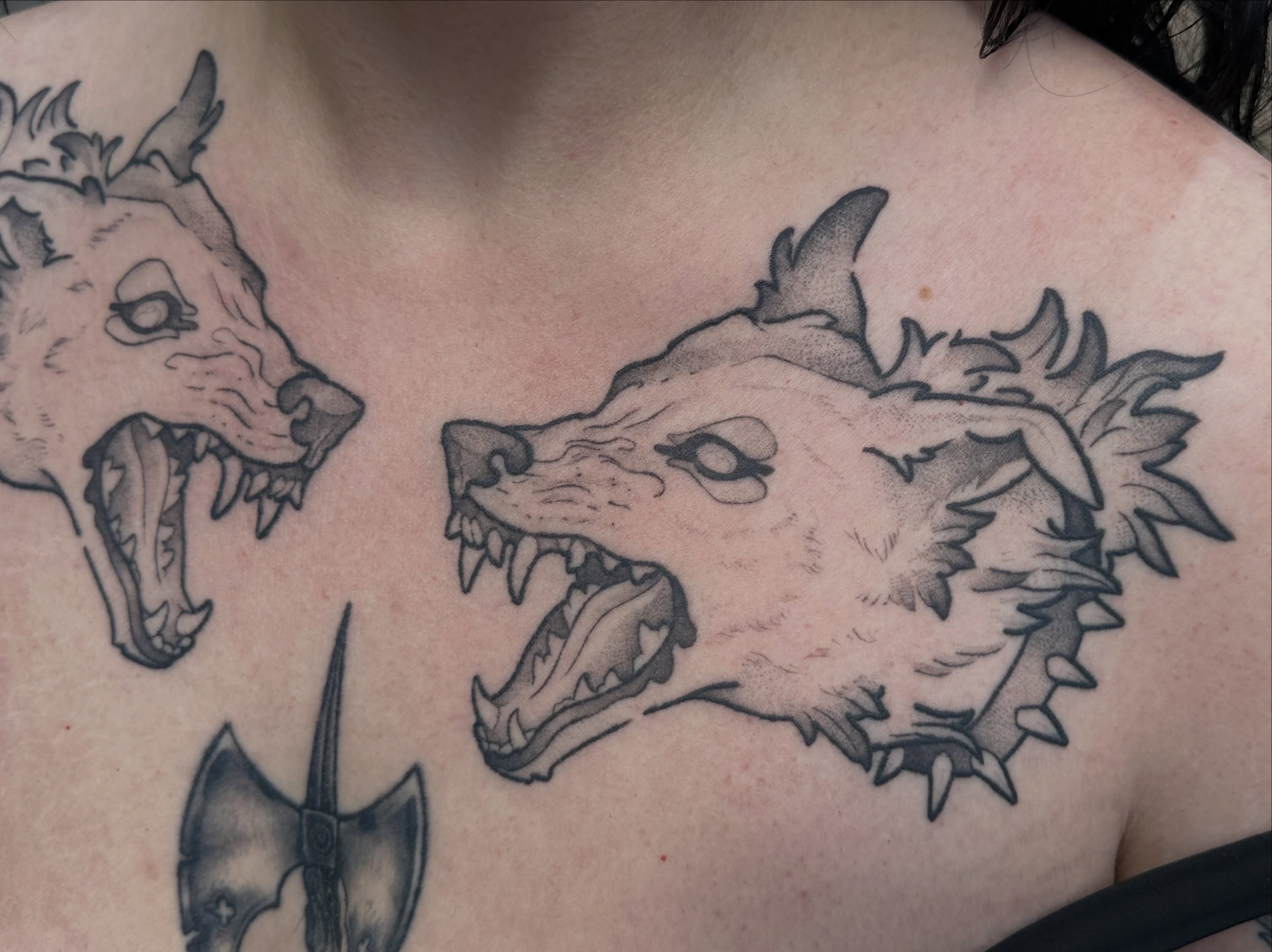 Wolf heads black and grey tattoo on the chest by TATTOOLIZARD (James)