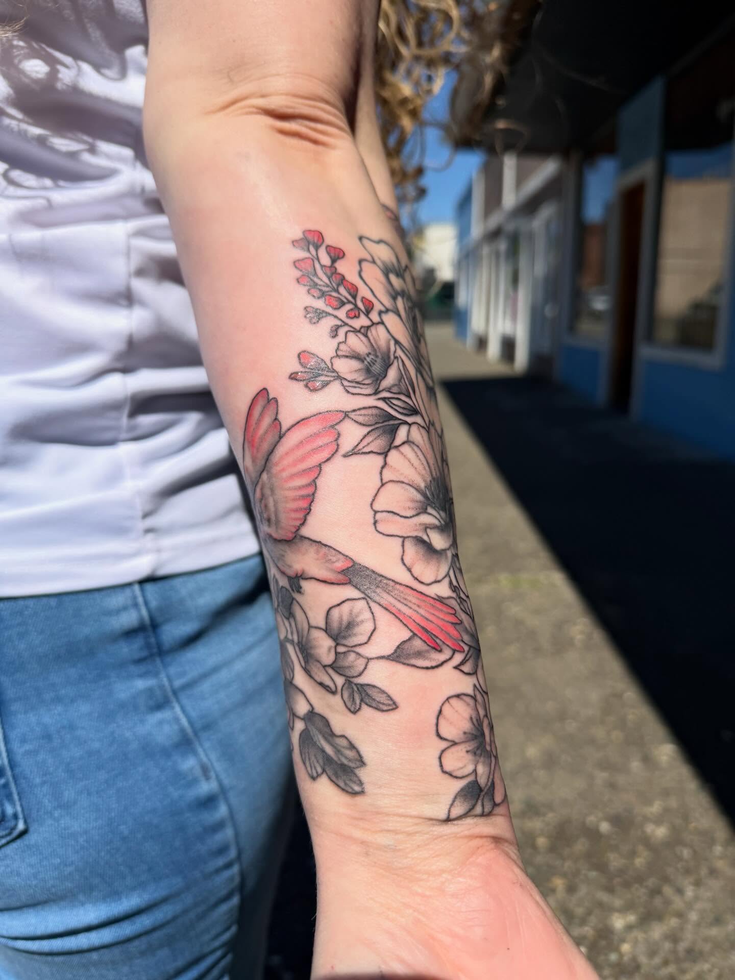 Bird and flowers black and grey tattoo on the forearm by Harlow ❤️‍🔥