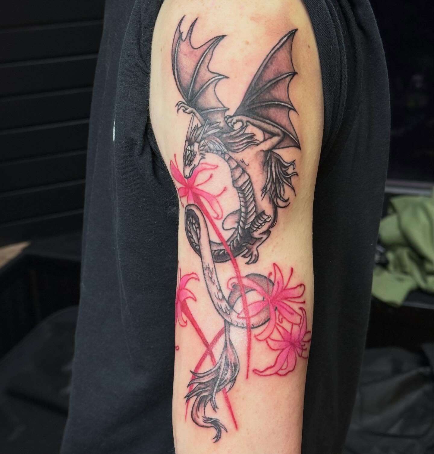 Dragon and flowers realism tattoo on the forearm by Nic