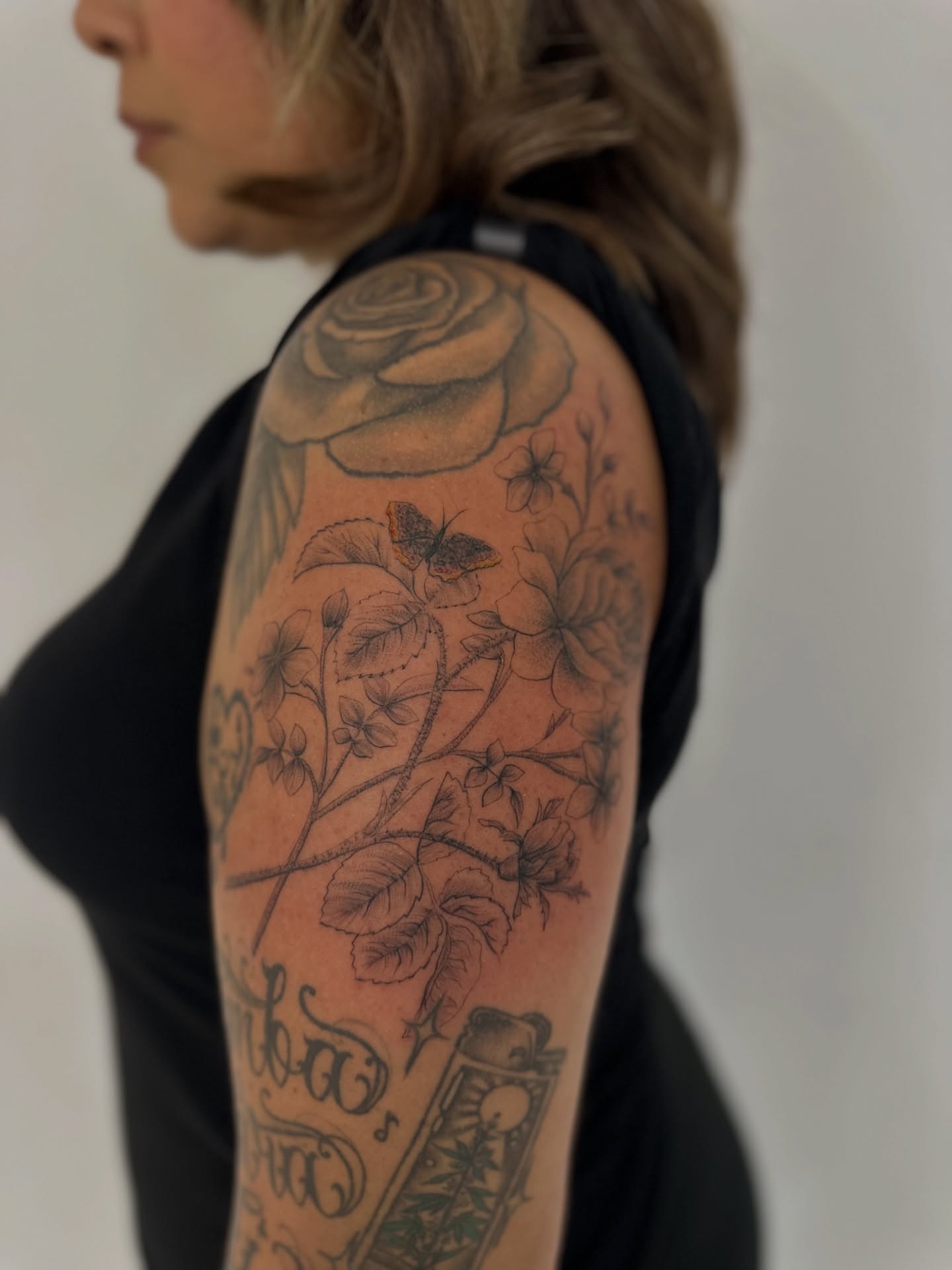 Floral bouquet realism tattoo on the upper arm by Ric Castellon Tattoo Artist, Los Angeles, California