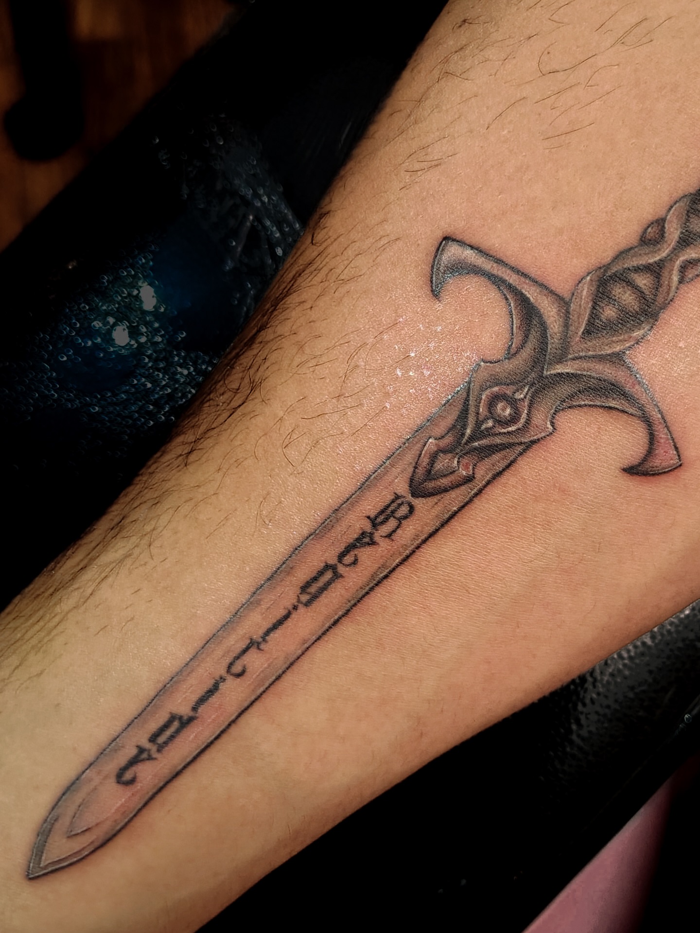 Sword black and grey tattoo on the forearm by Nahomi Luna - Memphis & Cordova Tattoo, Memphis, Tennessee