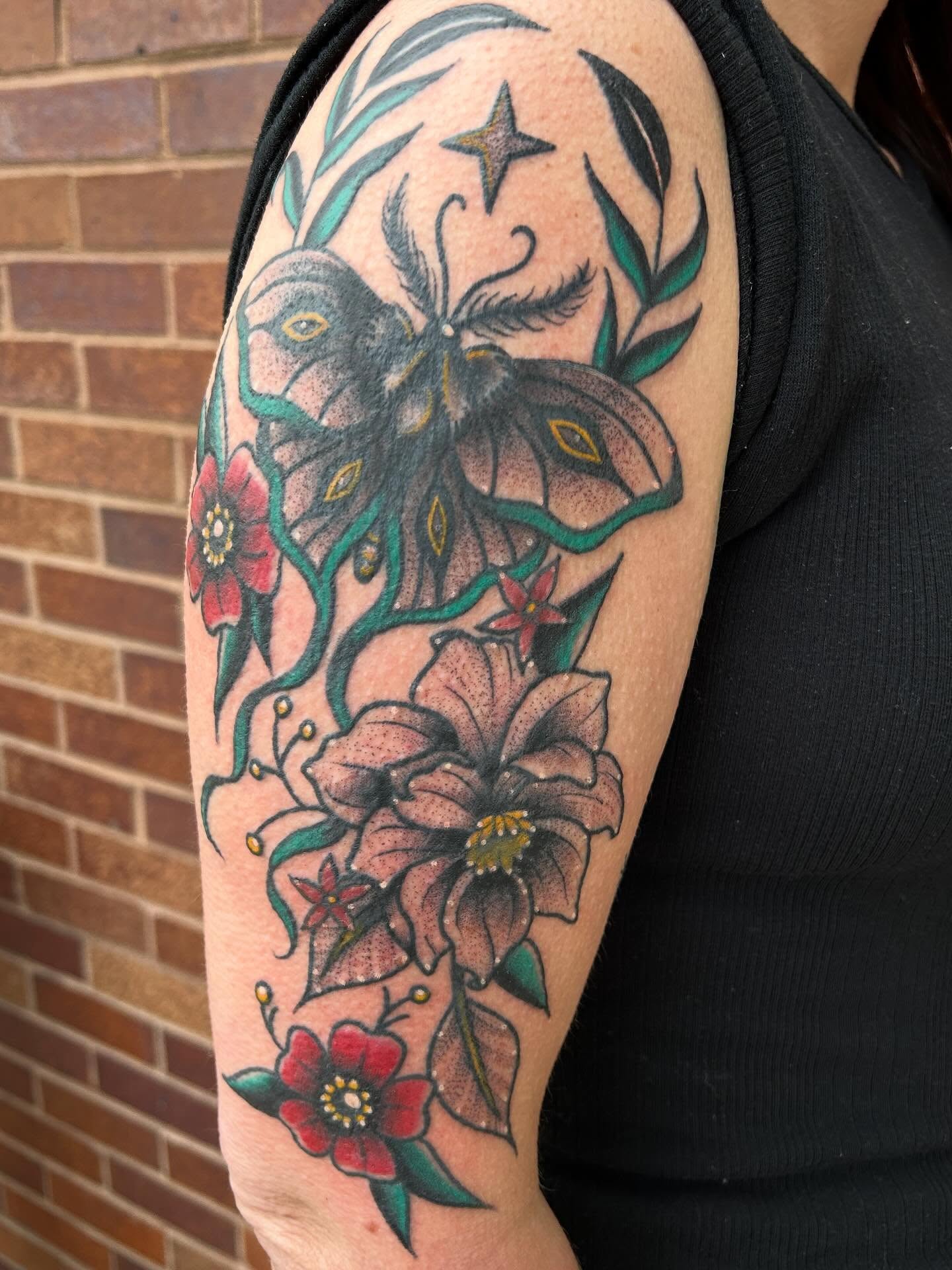 Butterfly and flowers American traditional tattoo on the forearm by Morgan Hazer Tattoos, Cedar Rapids, Iowa
