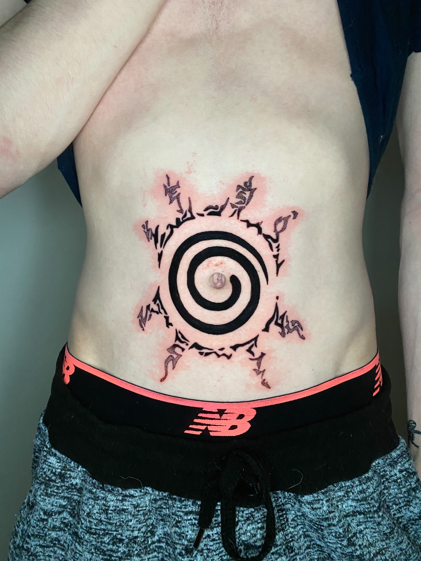 Spiral with tribal elements geometric tattoo on the torso by Aidan Leery, Portland, Oregon