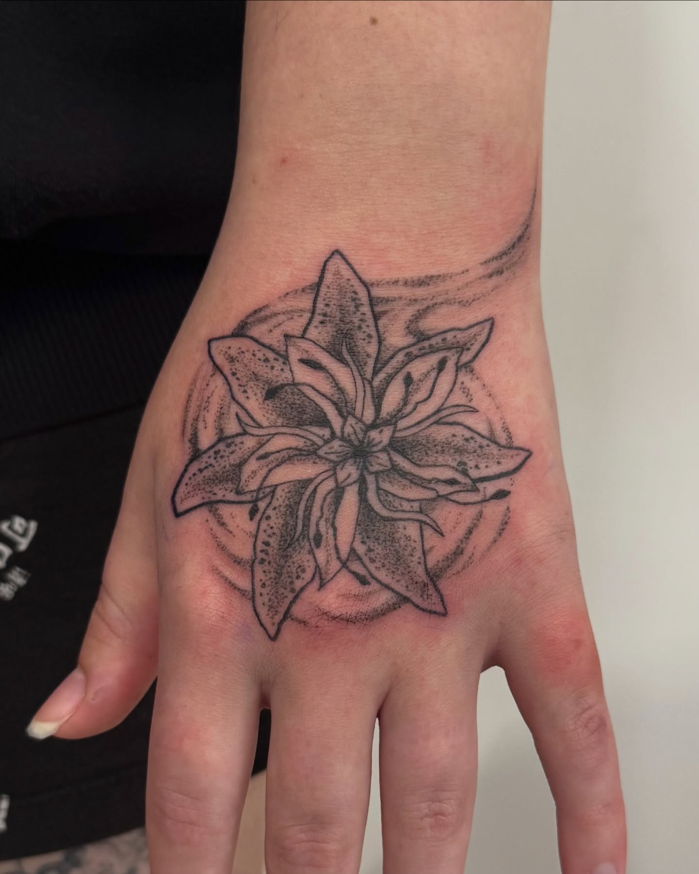 Lily dotwork tattoo on the hand by jake.inks