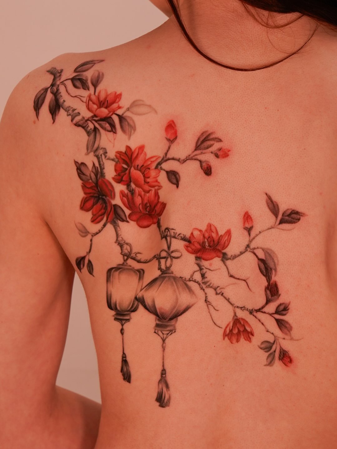 Cherry blossoms and lanterns realism tattoo on the chest by Nicki Yến