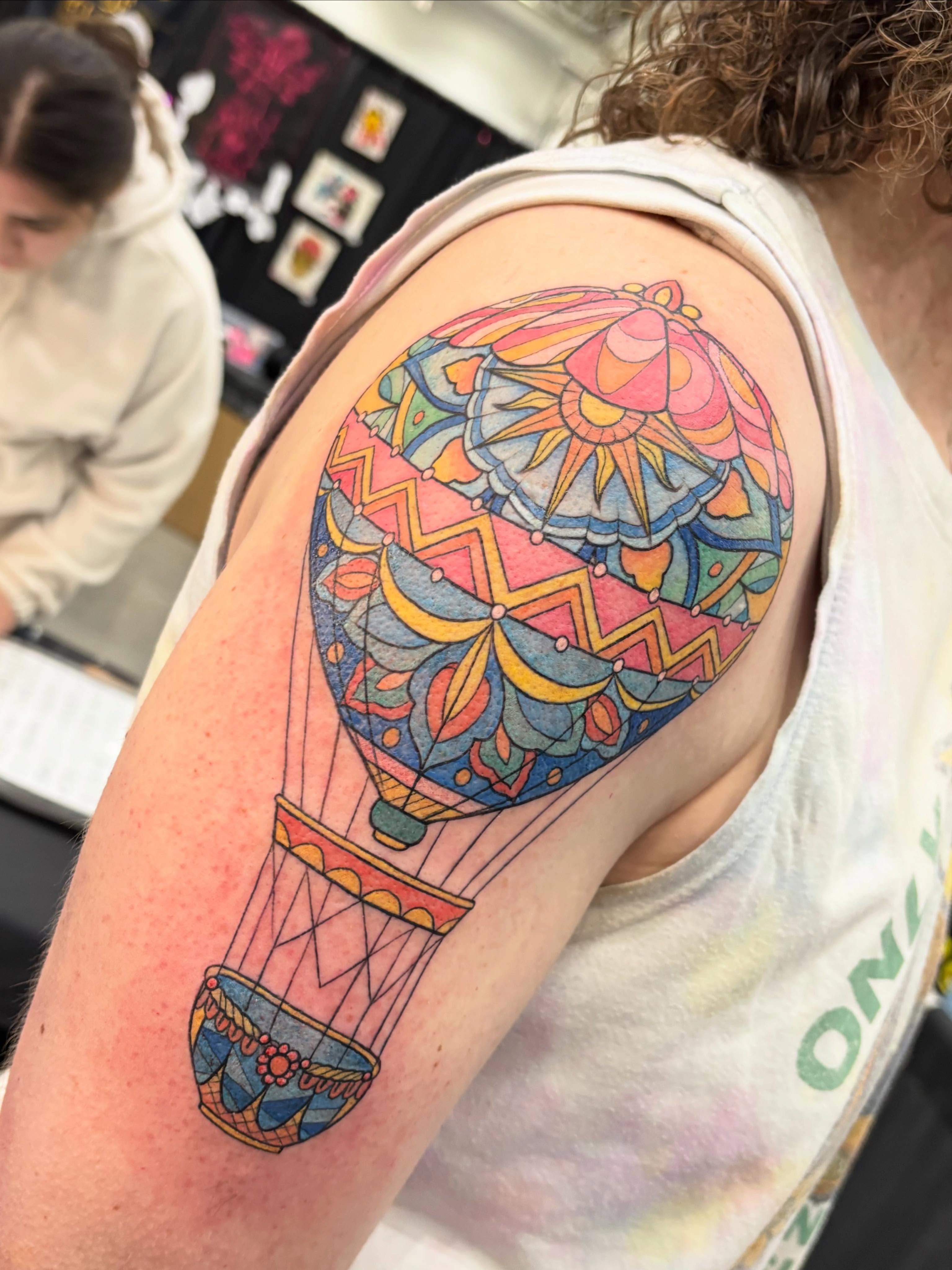 Hot air balloon geometric tattoo on the shoulder by Jennifer Flores