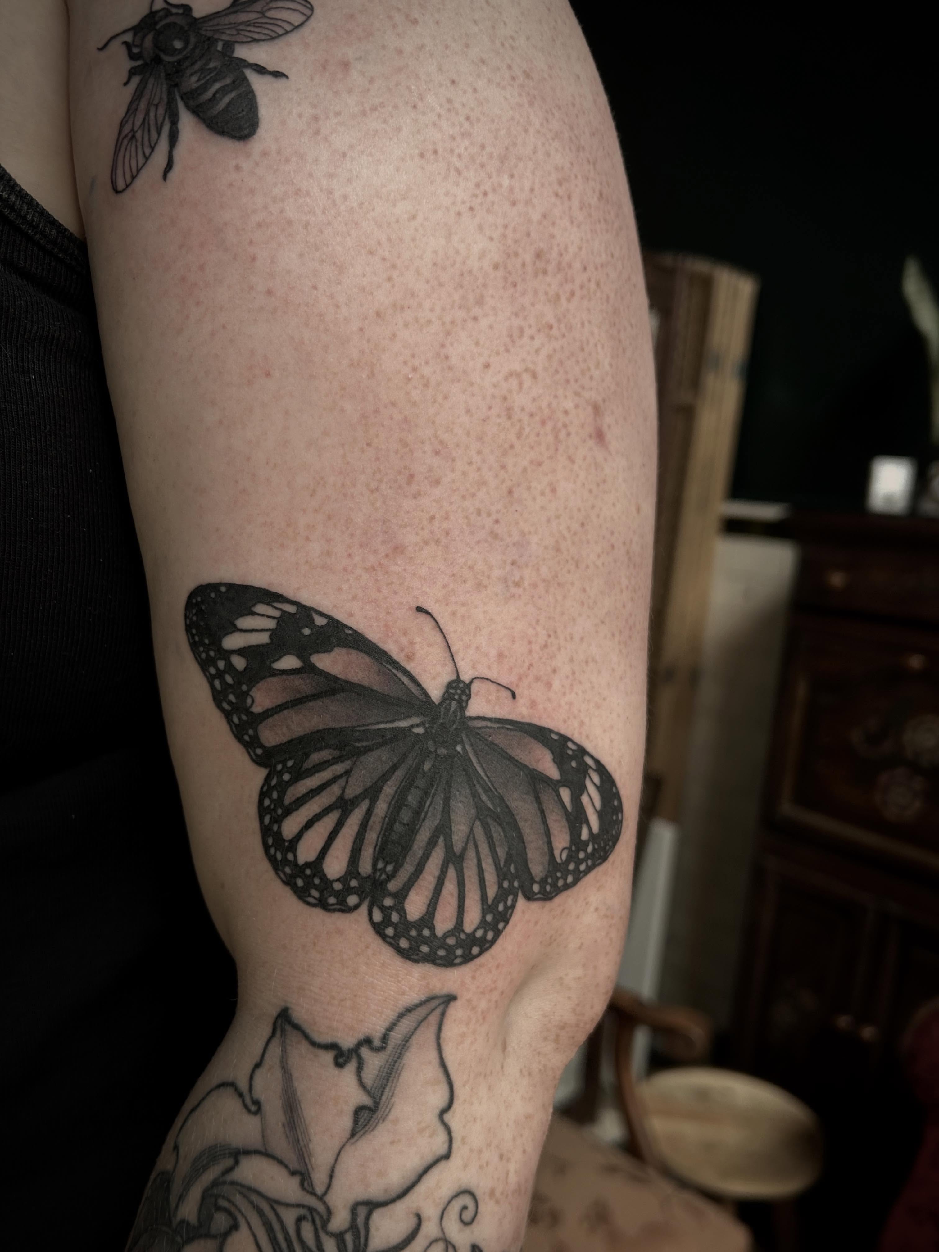 Butterfly black and grey tattoo on the forearm by ꧁𝙺𝚊𝚛𝚒𝚗𝚊꧂, Grinnell, Iowa